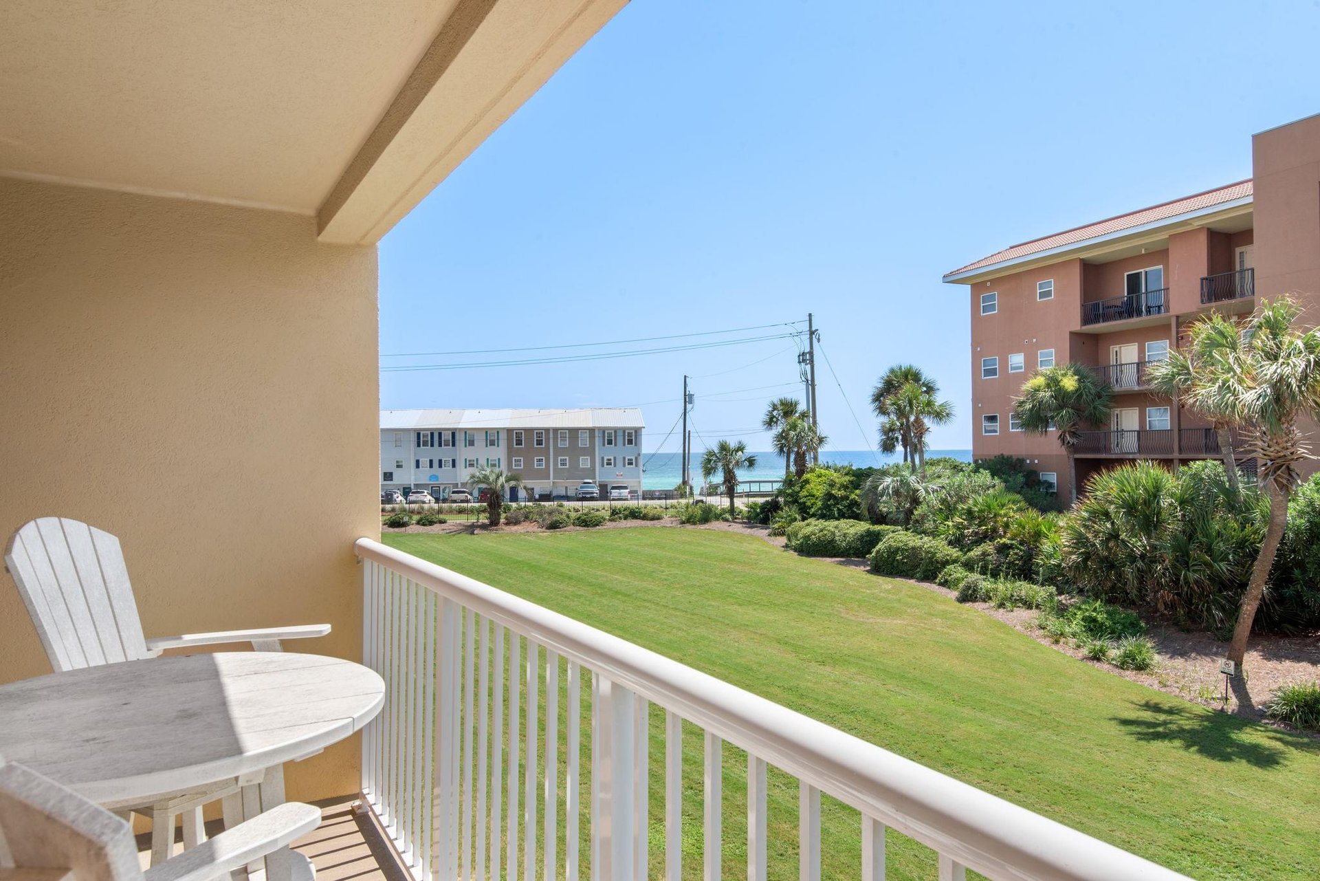 Step onto your private balcony and take in the ocean glimpses beyond the lush tropical landscaping. Settle into your seat and enjoy coastal breezes, listening to the waves crashing on the sugar sand b
