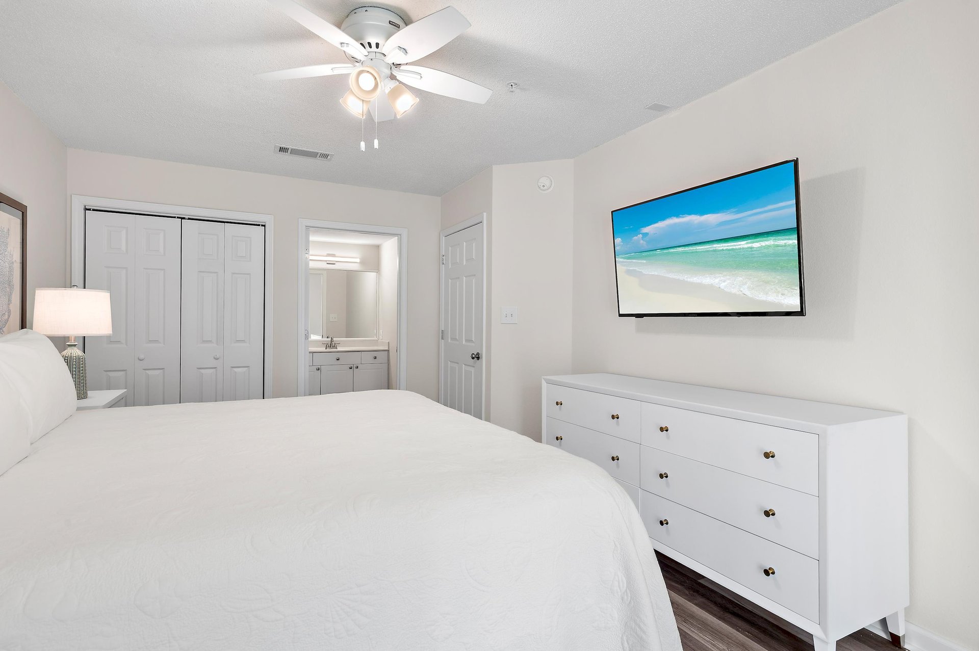 This bright, serene Primary Bedroom invites you to curl up while you watch your favorite show or movie on your Wall Mounted TV.
