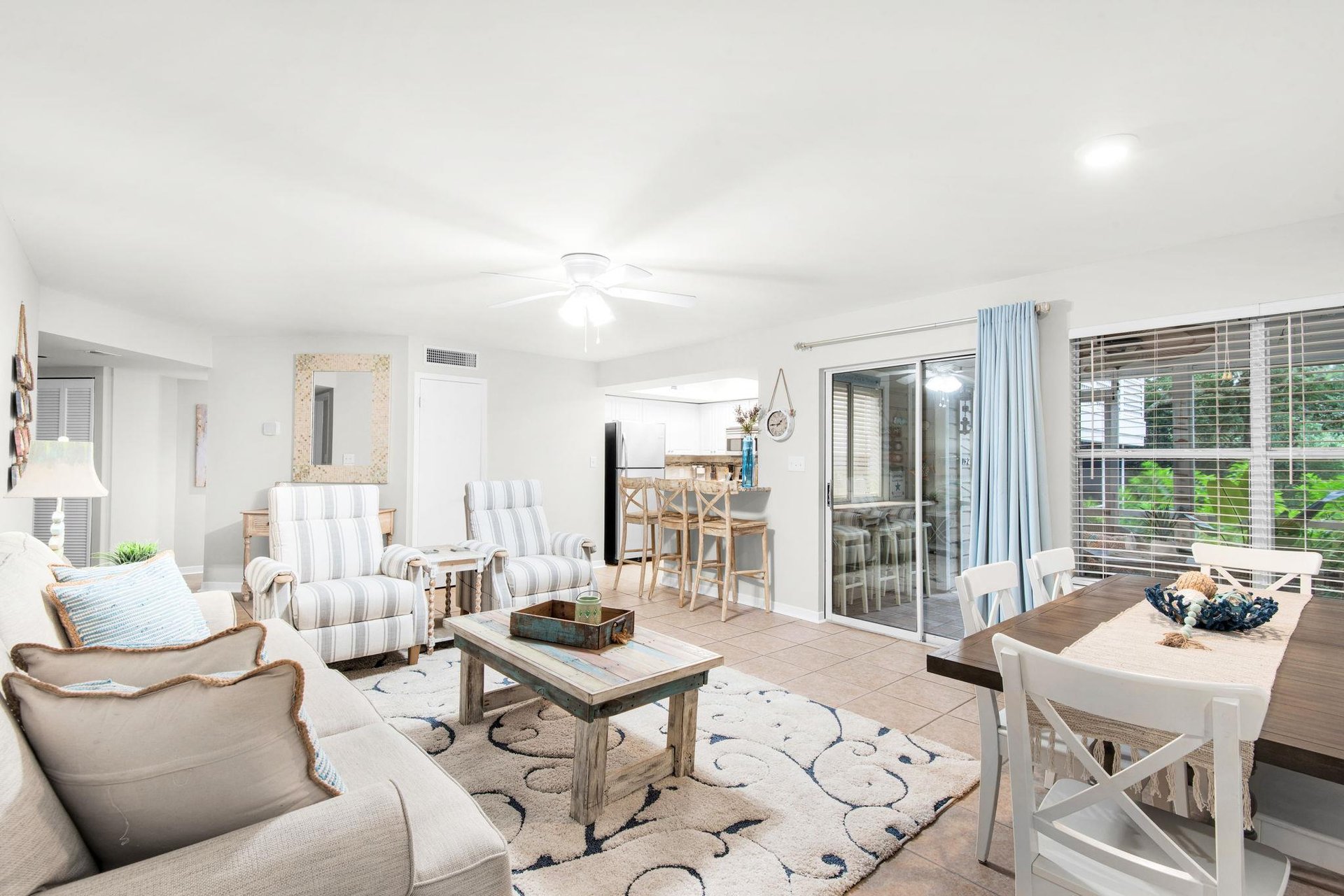 Relax in your spacious living room with comfortable seating, coastal charm, and easy access to your private balcony where you can unwind and enjoy the fresh air.
