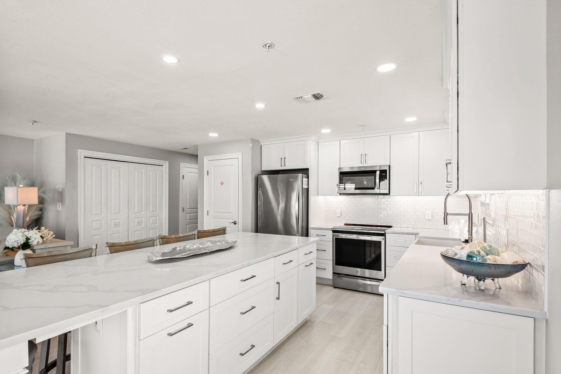 Your modern kitchen is designed for easy meal prep, with sleek white cabinetry and stainless appliances