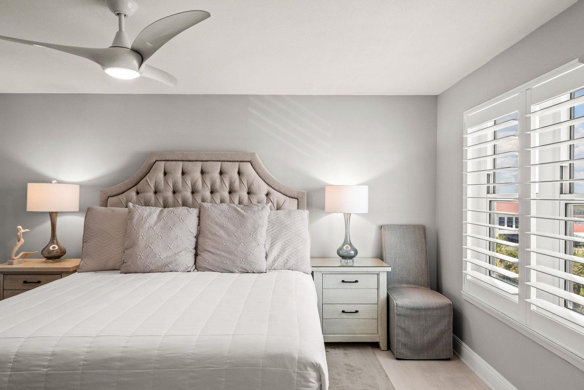 Unwind in this serene bedroom with plush bedding and elegant tufted headboard.