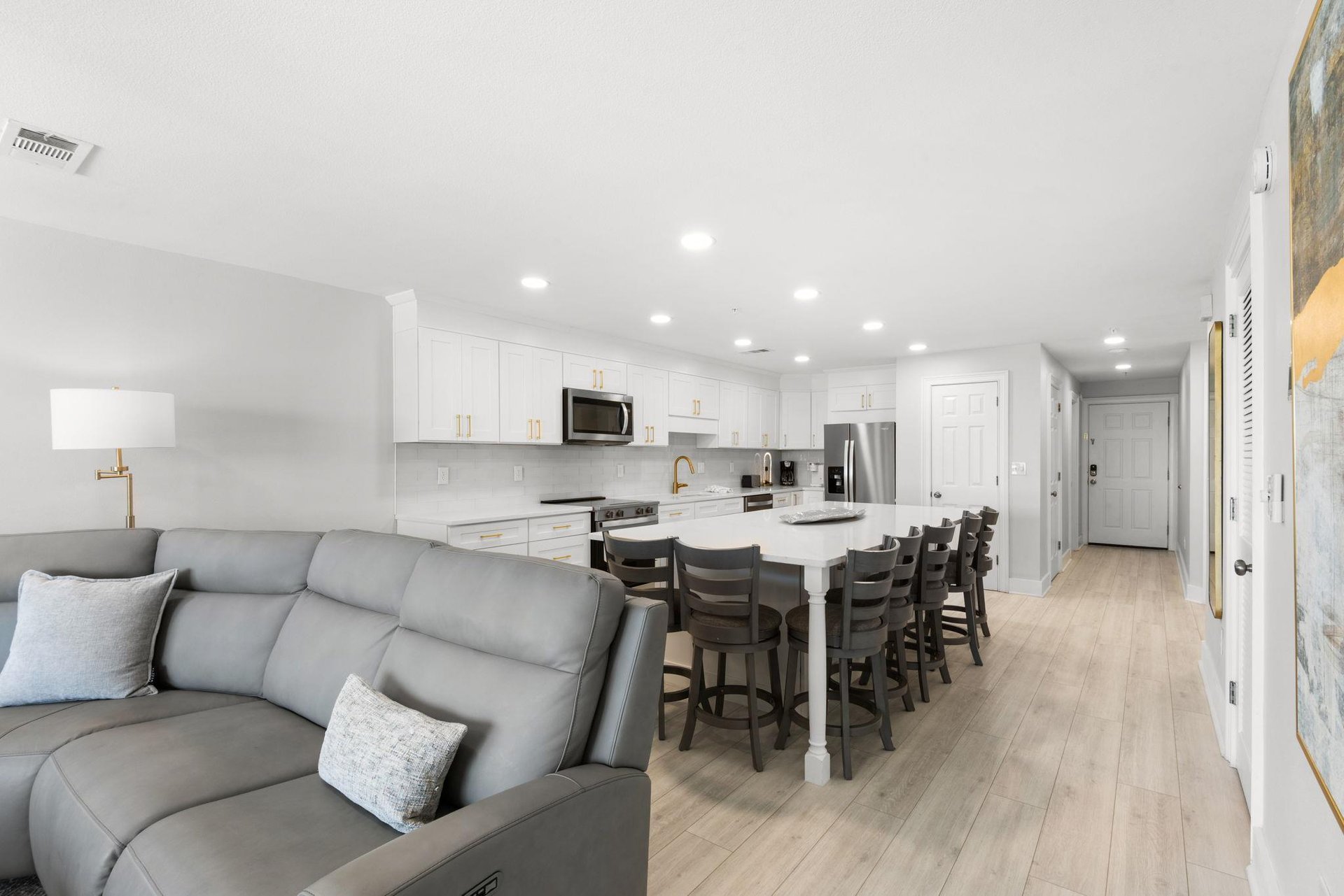 Relax in your bright openplan living space, where a sleek kitchen with stainless appliances flows into a cozy living area and dining island perfect for gathering with loved ones.