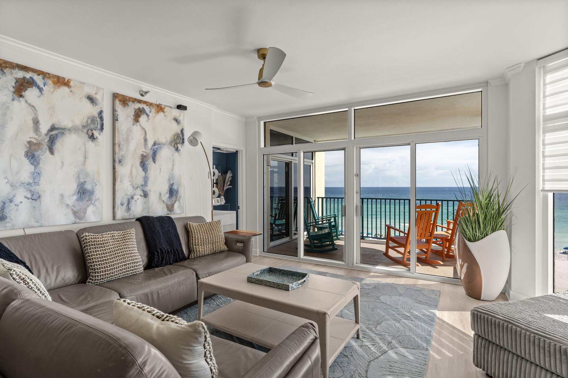 Sink into this inviting living room where coastal elegance meets comfort, and step onto your private balcony to soak in stunning ocean views stretching to the horizon.