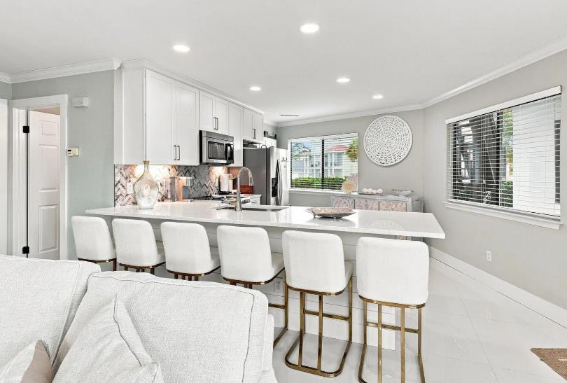 Gather around the spacious island in your sleek, modern kitchen—perfect for morning coffee or a casual meal together after exploring the area.