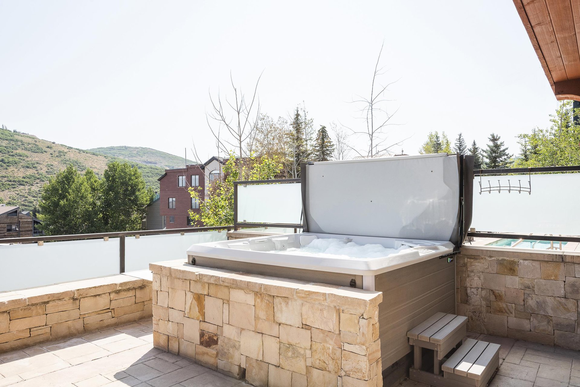 Private hot tub with flagstone wall, convenient steps to access jacuzzi