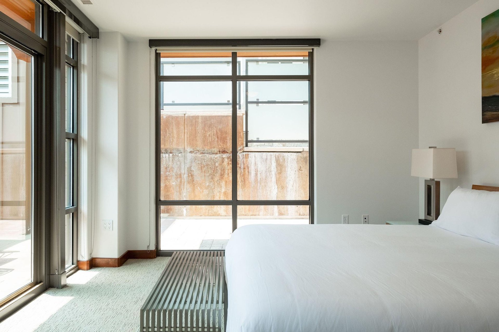 Main bedroom suite, gridiron stainless steel bench at the foot of the bed and stunning window walls