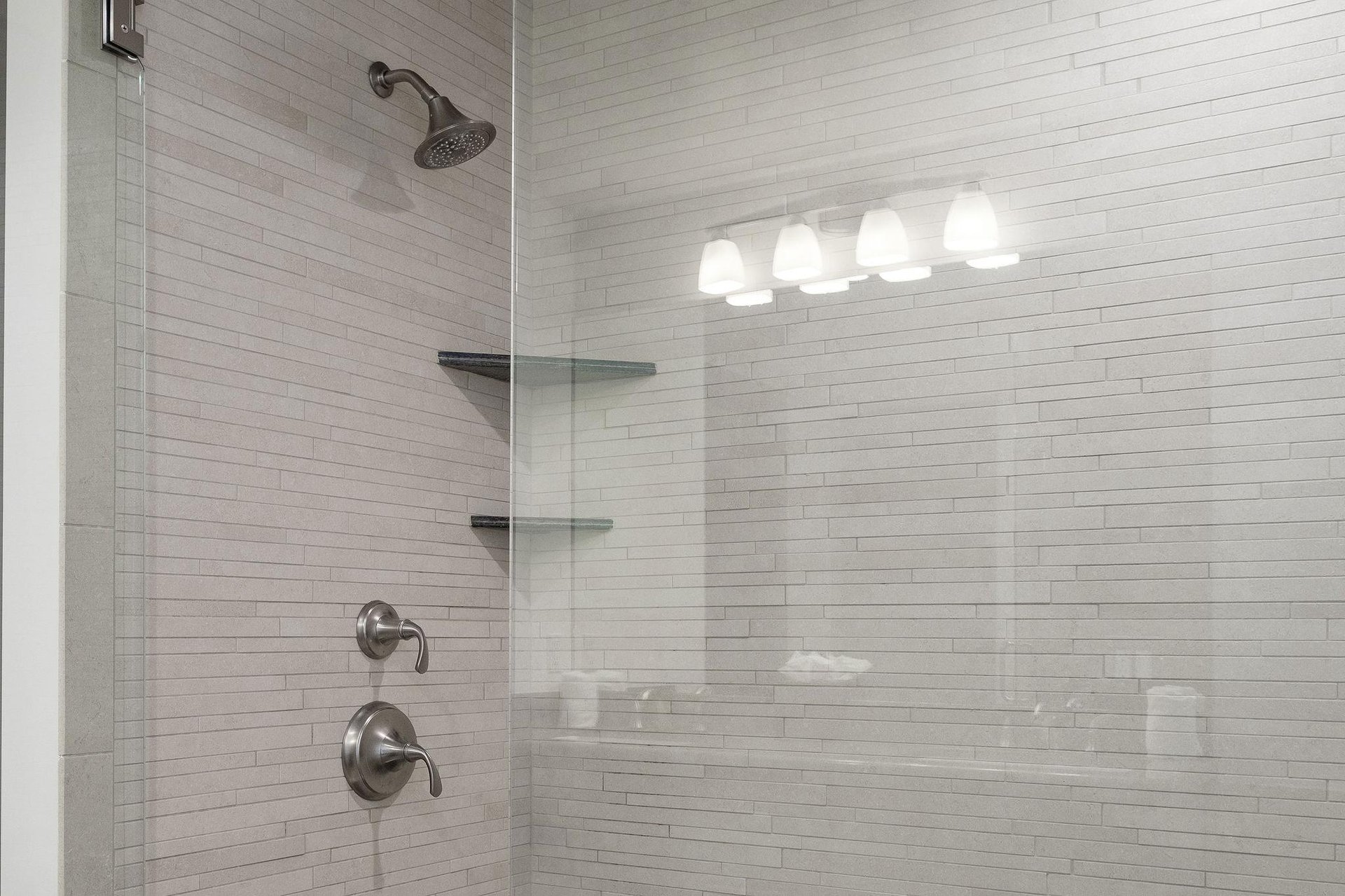 Tiled shower with glass panel doors