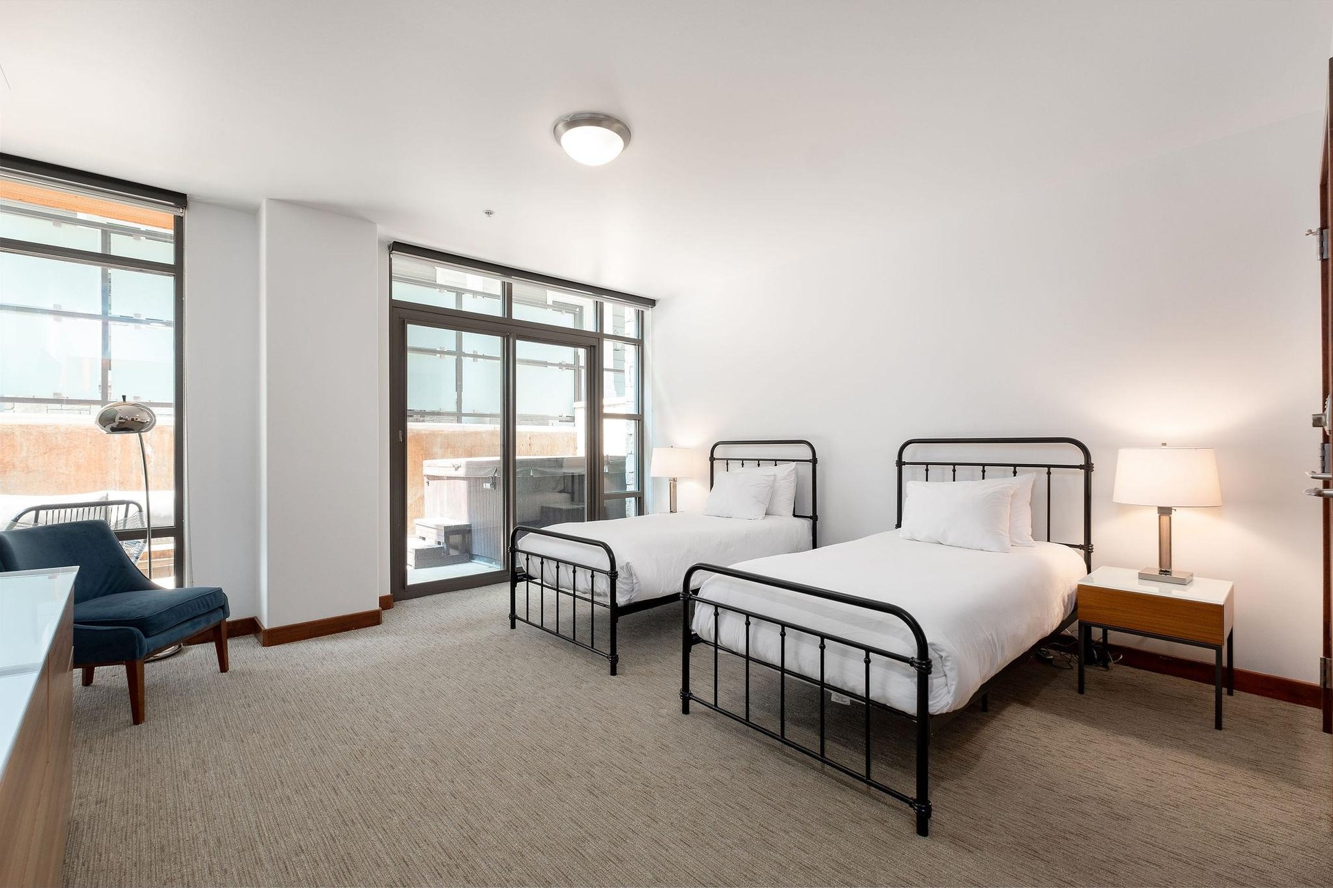 Twin beds with vertical bar metal bedframes, can be converted to a king with advance notice