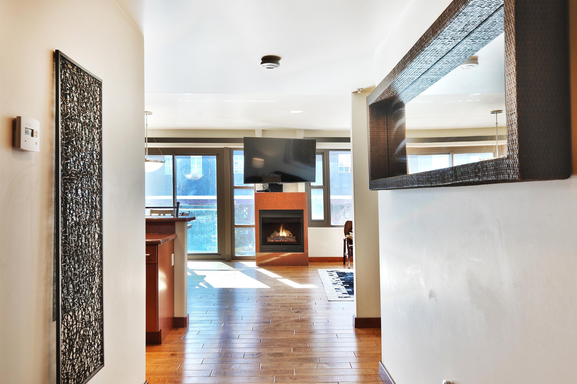 Entryway corridor looking toward the fireplace and flat screen TV