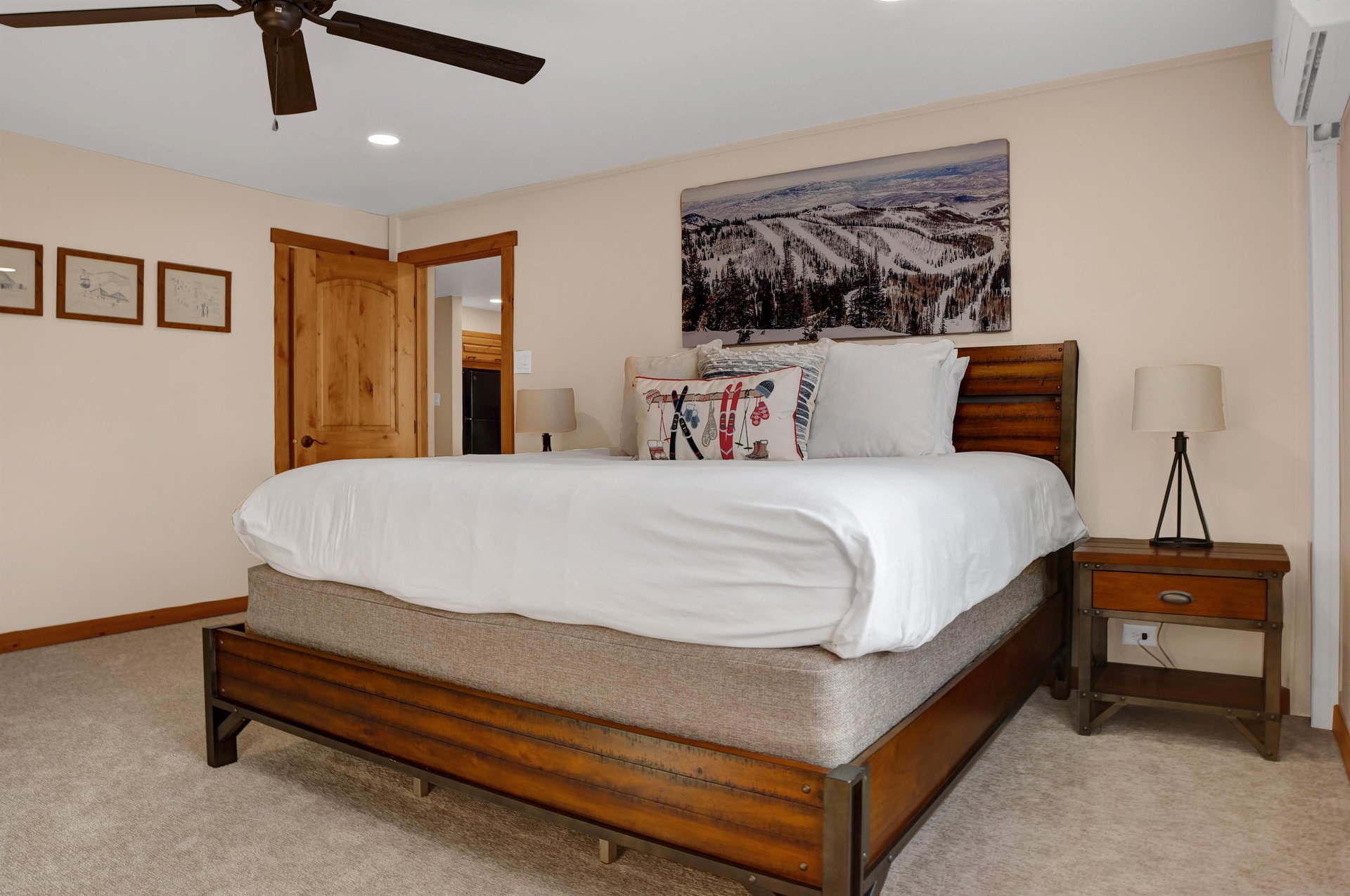 King bed with large picture window overlooking the resort plaza