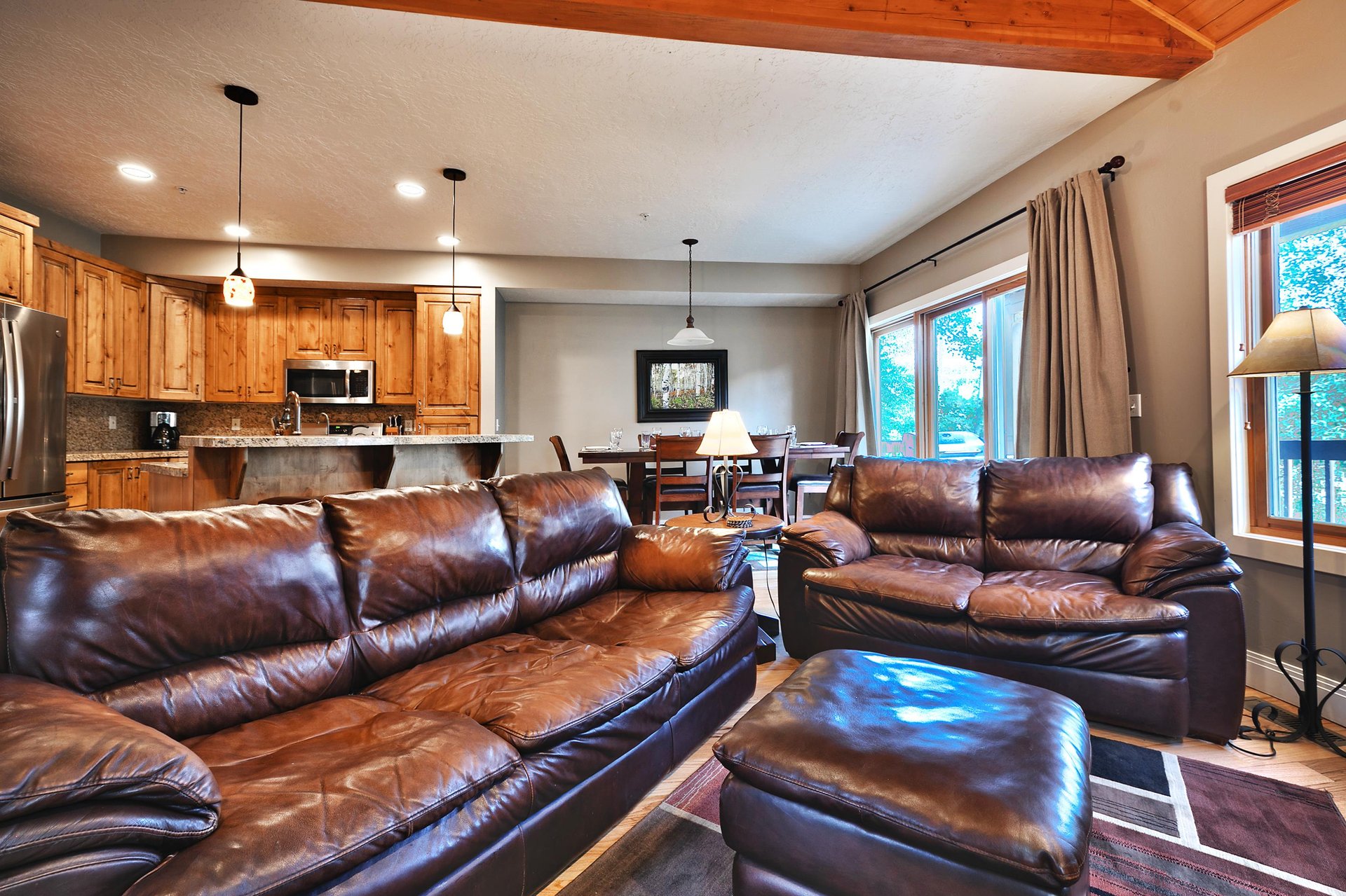 Living room with kitchen and dining room in the background