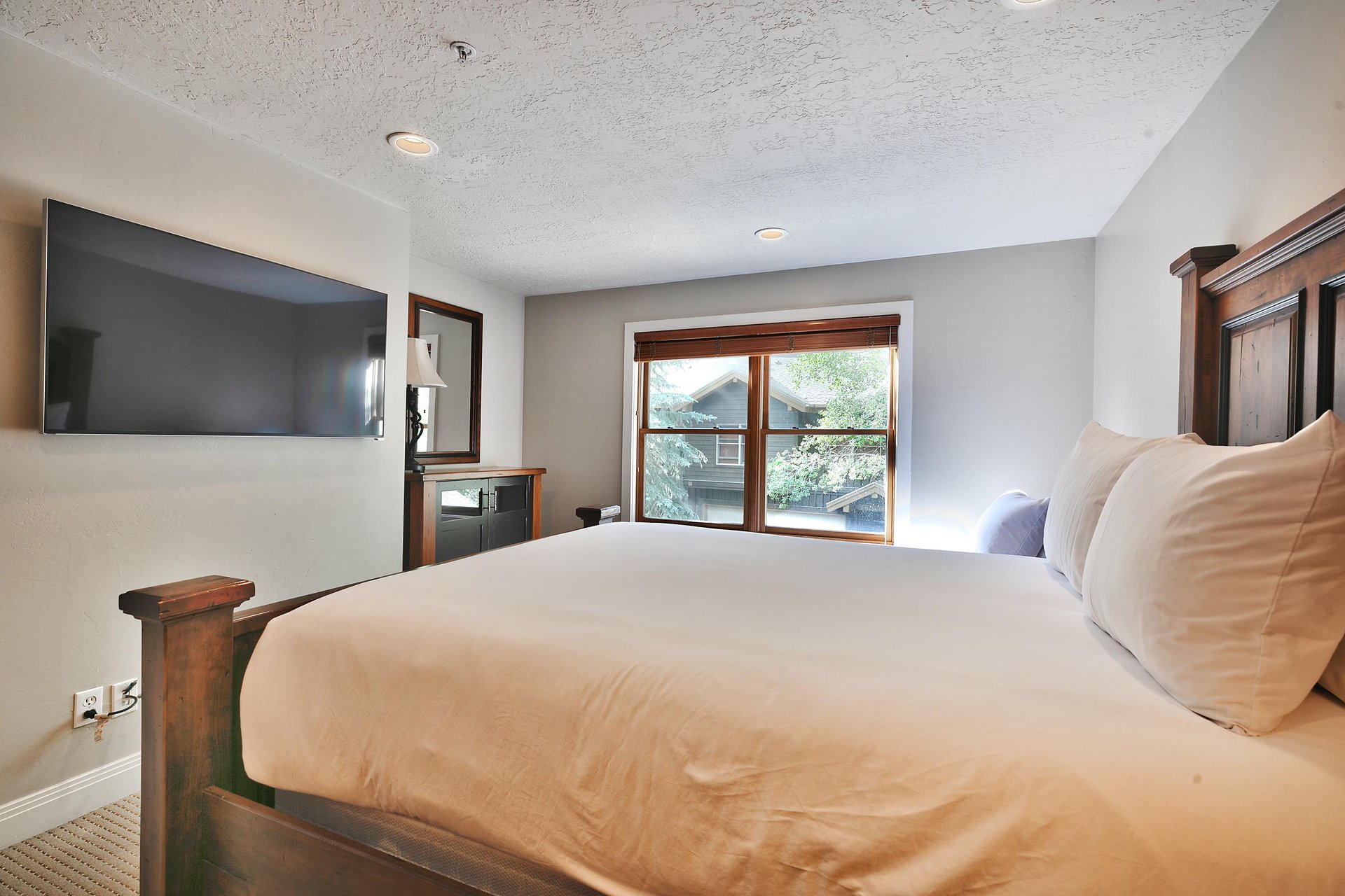 Guest bedroom with queen  twin bed and wall mounted flat screen TV