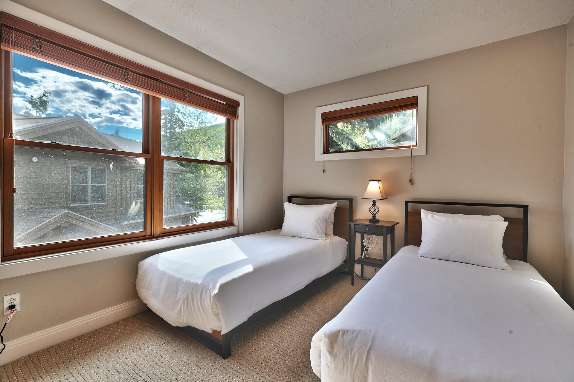Guest bedroom with two twin beds and large picture window