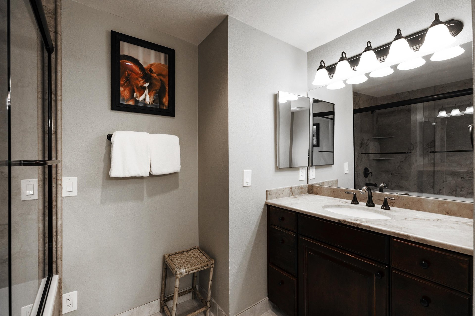 Ensuite main bathroom includes another vanity  white granite countertops, Alderwood cabinets and large mirror with a vanity light