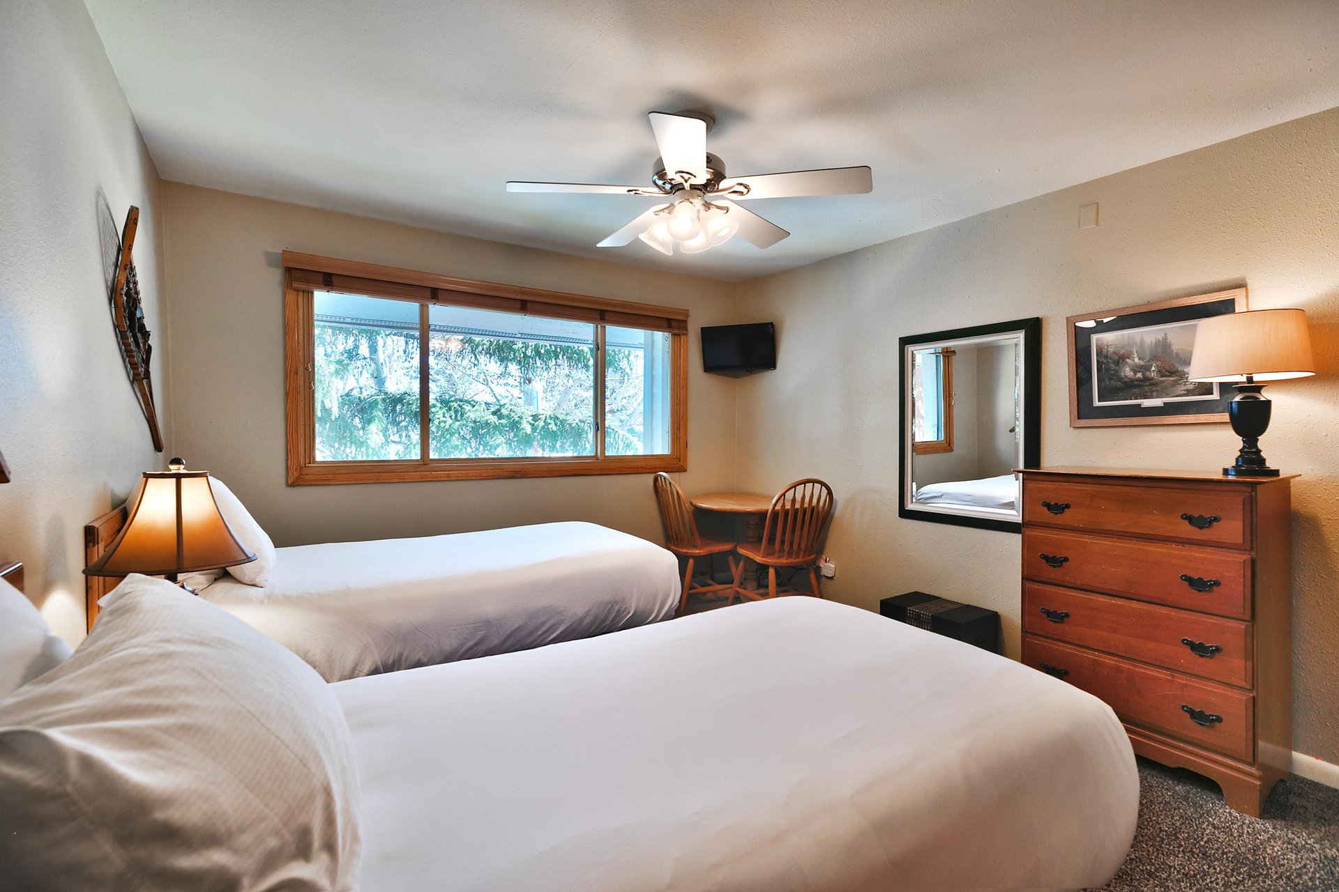 Second bedroom features a wall mounted flat screen TV