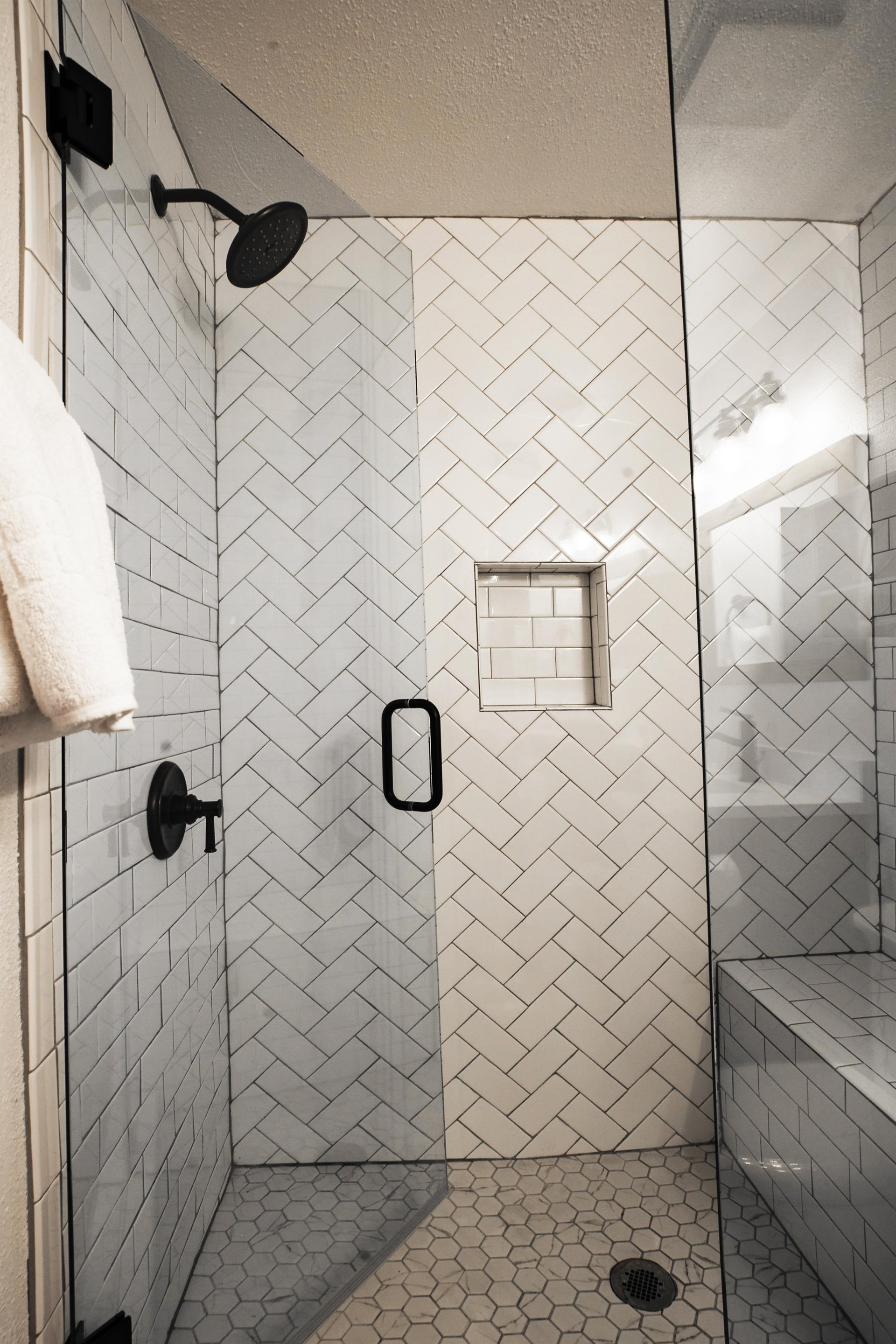 Ensuite main bathroom includes a modern walkin tiled shower with a bench