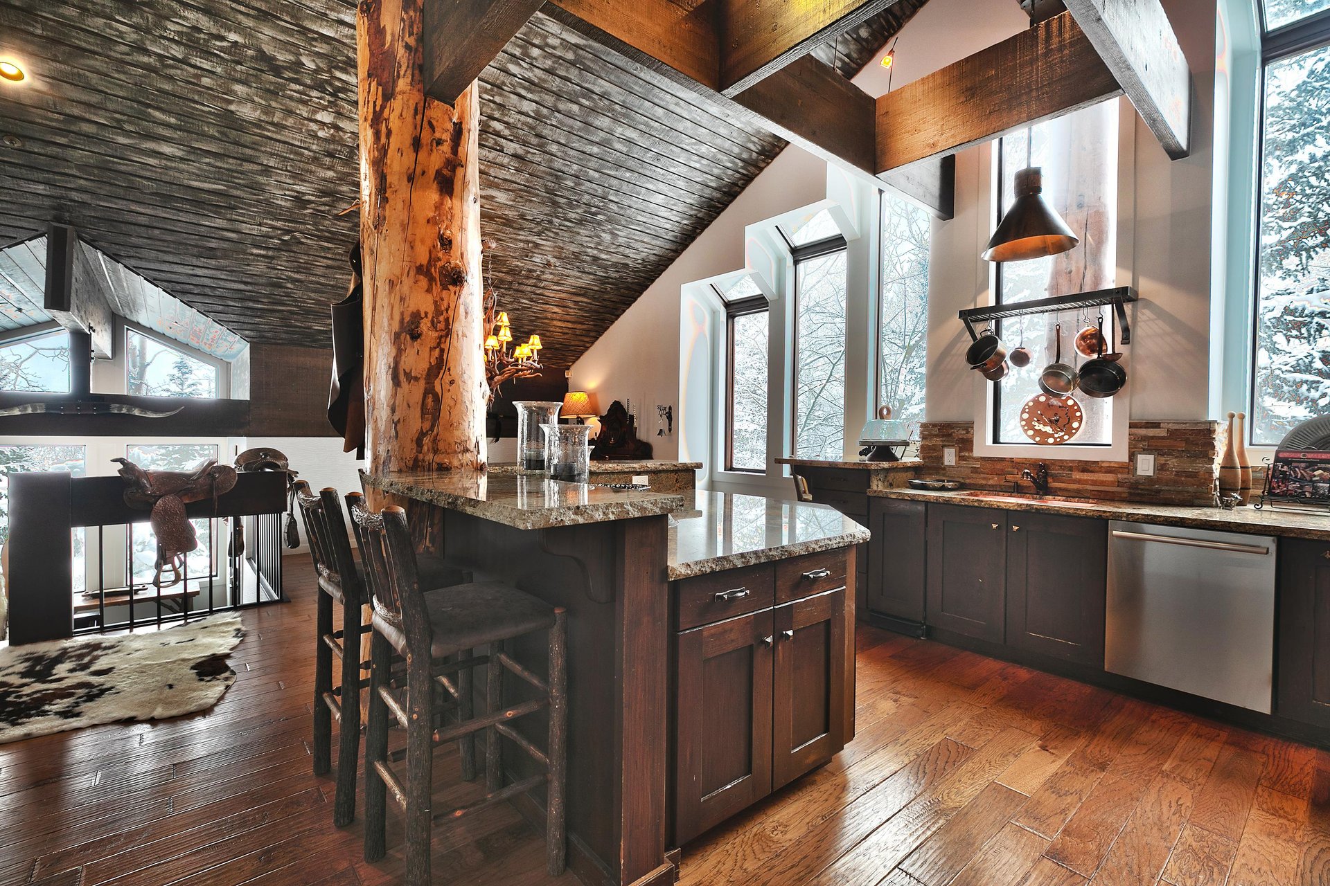 Additional seating at the breakfast bar in the kitchen in log style barstools