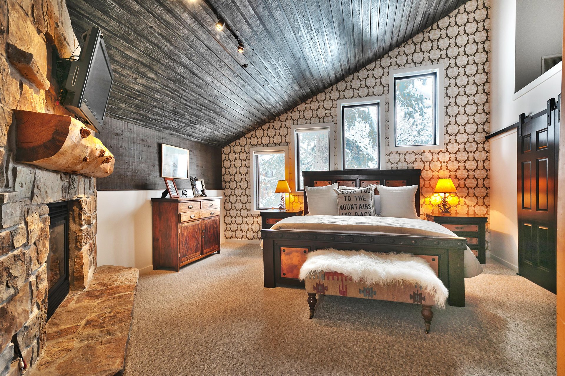Main bedroom suite with luxurious king bed, casement windows and southwestern upholstered bedroom bench