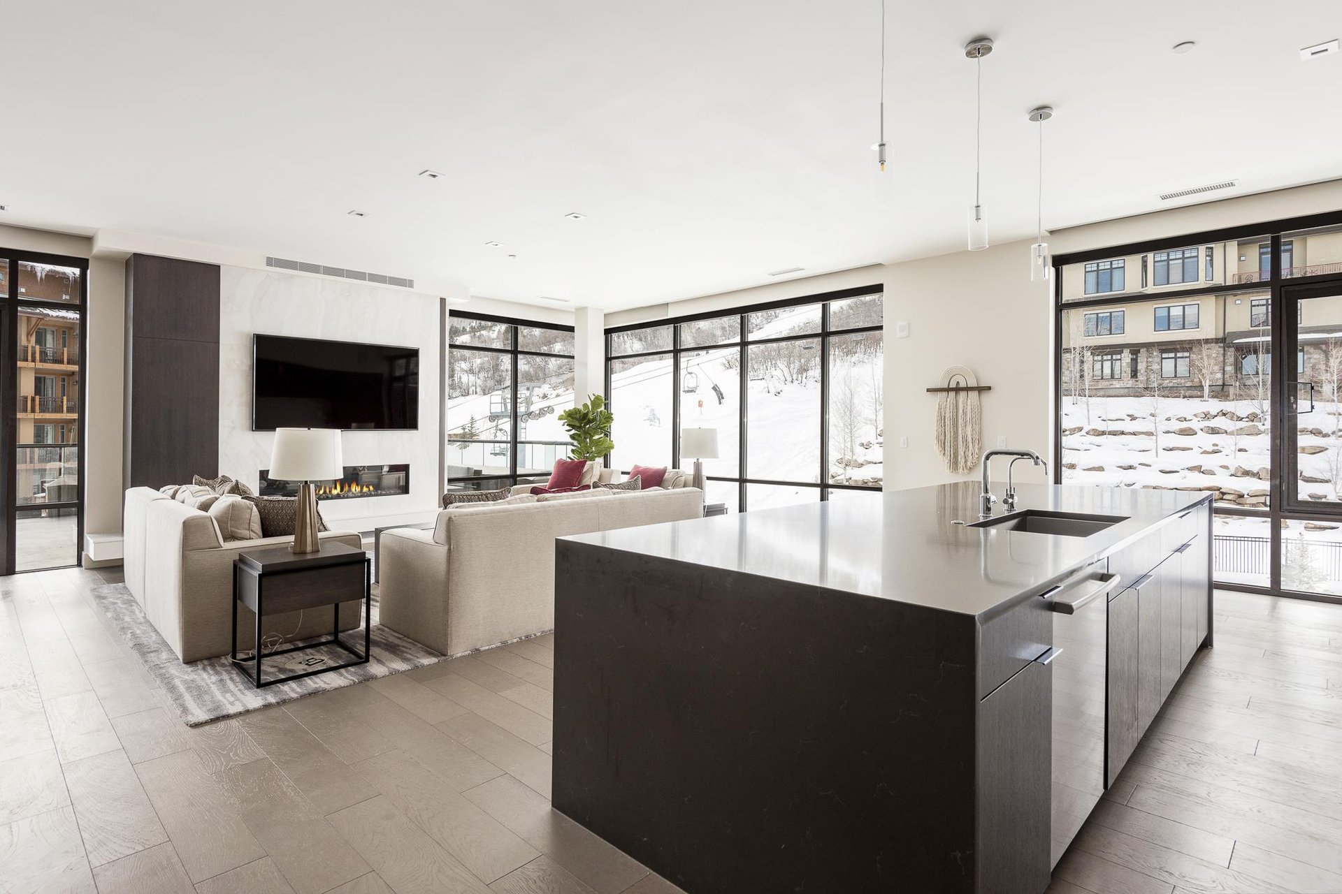 Open floor plan, kitchen overlooking the living room hardwood floors throughout and abundant natural light with window walls