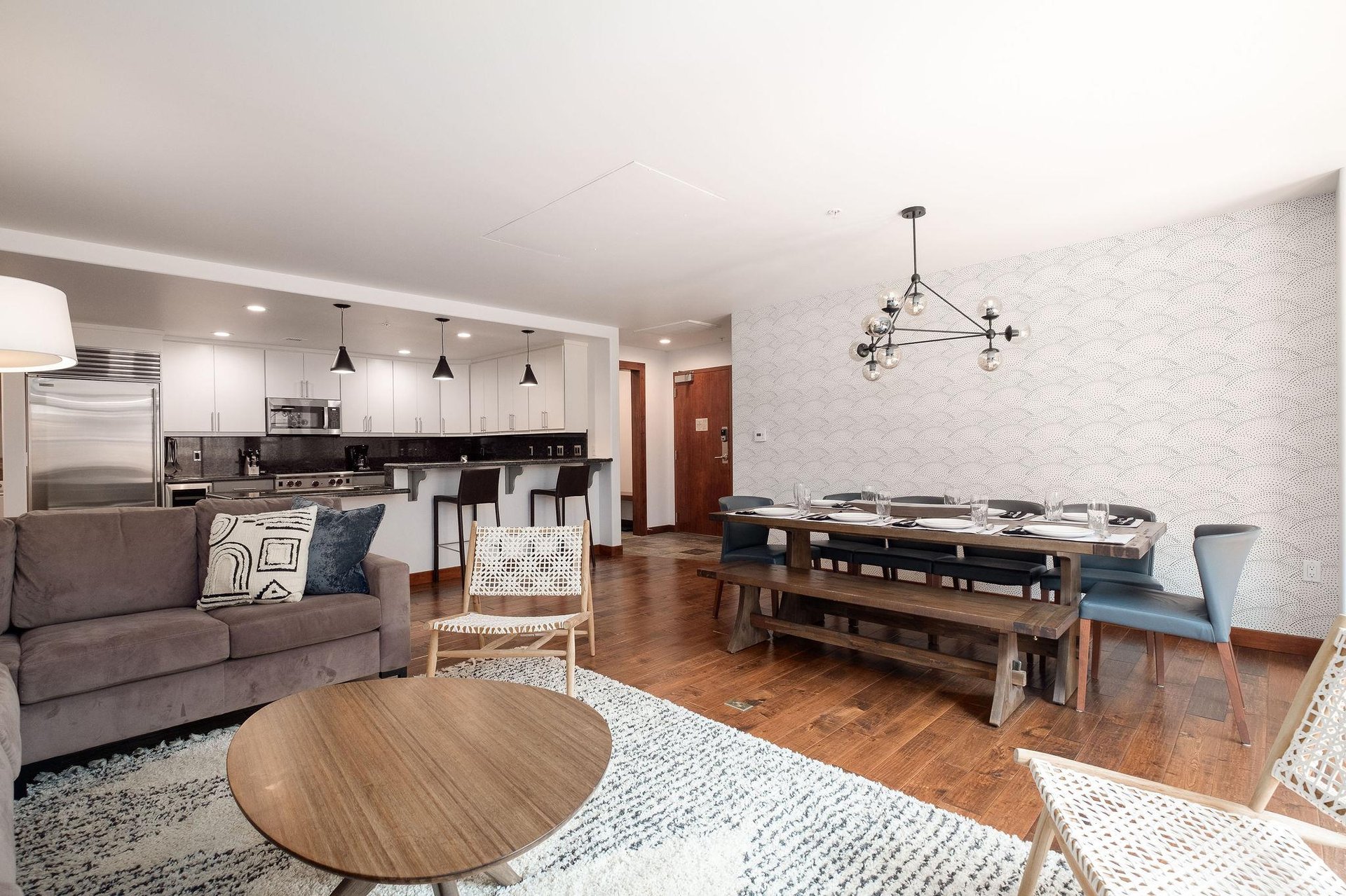 Living room looking toward the dining and kitchen area, modern updated condo