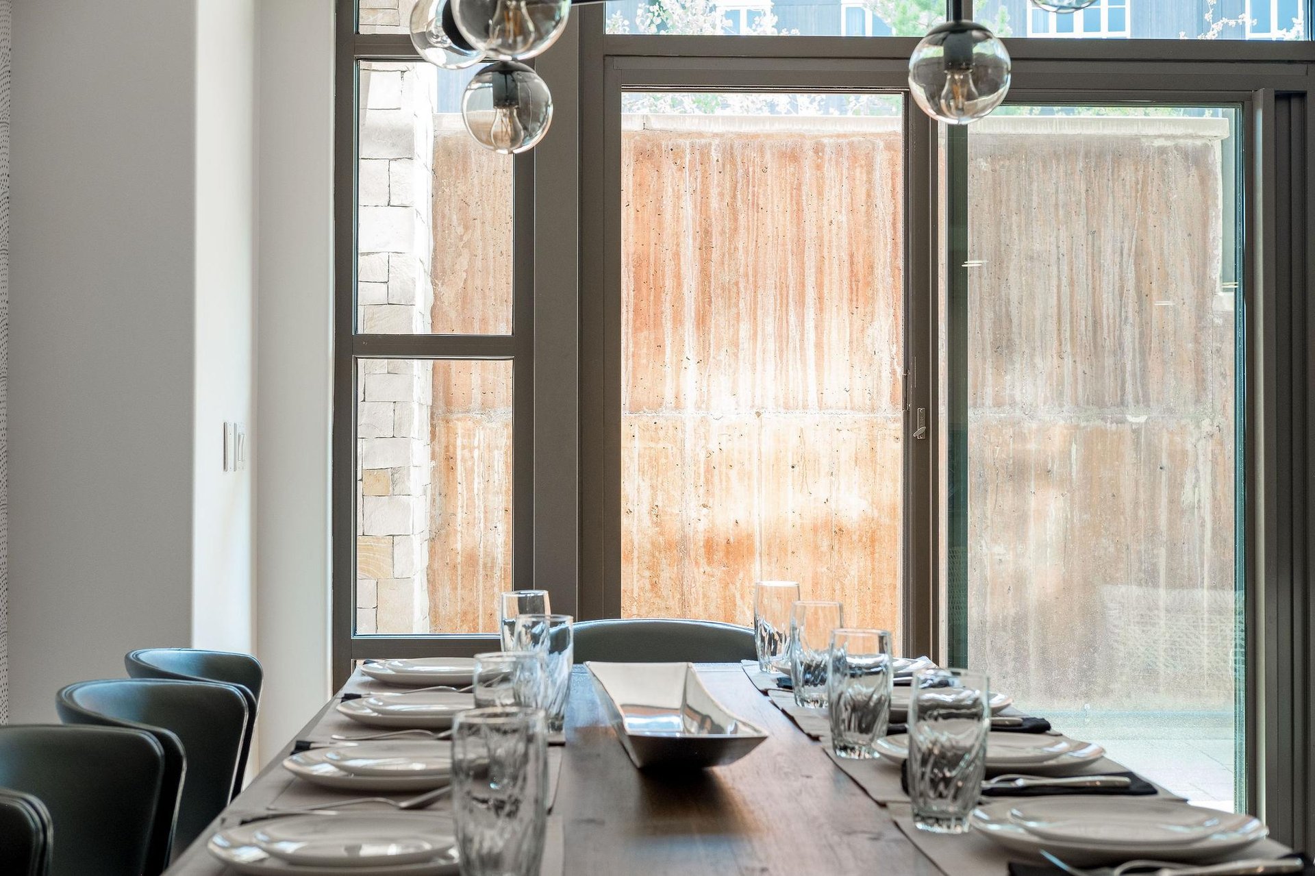 Abundant natural light in the dining room with large window walls and sliding glass doors