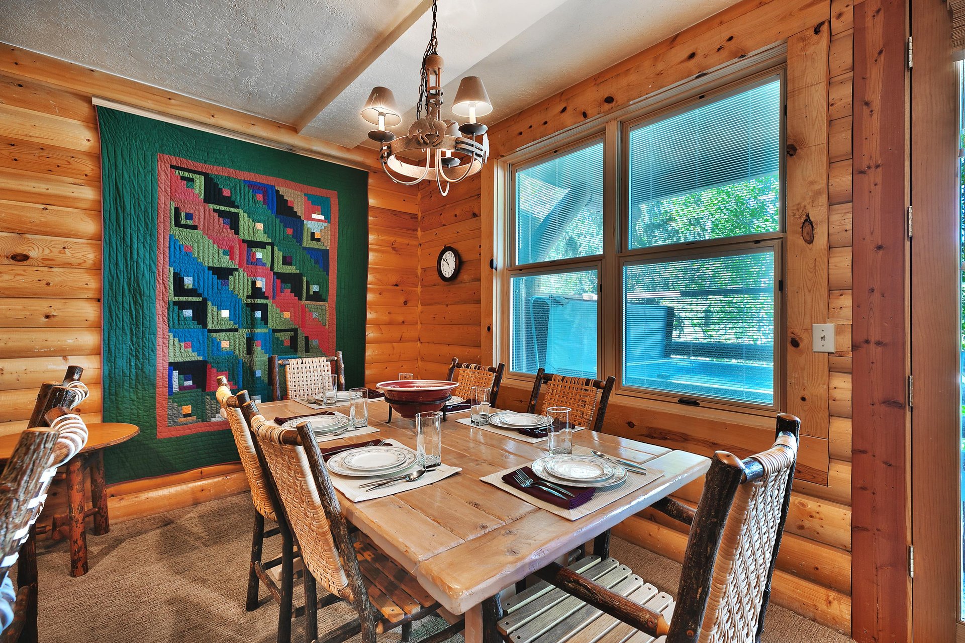 Solid wood dining room table with seating for 6 in high back log wood chairs