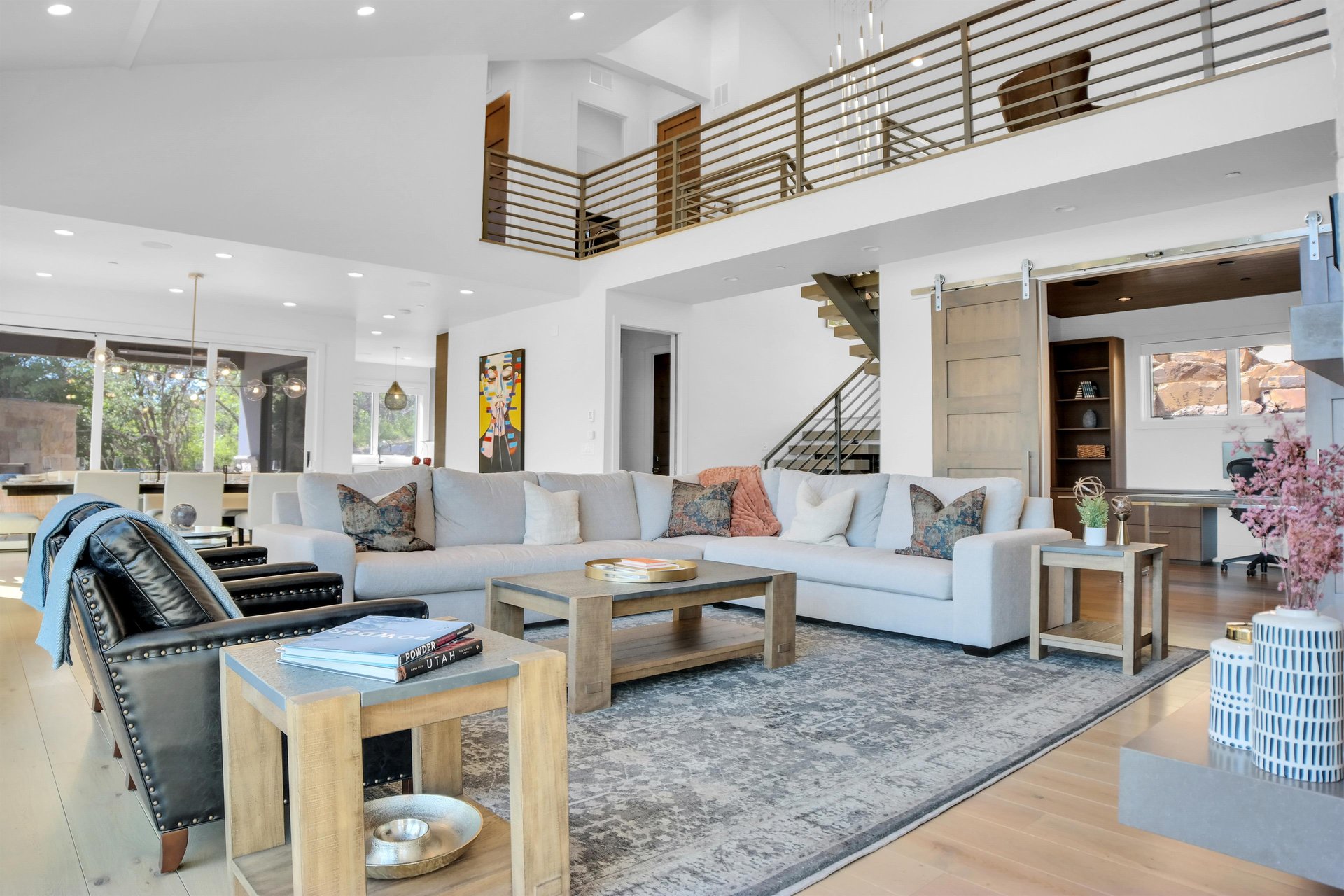 Vacation rental living room with wooden coffee tables and end tables and comfortable seating.