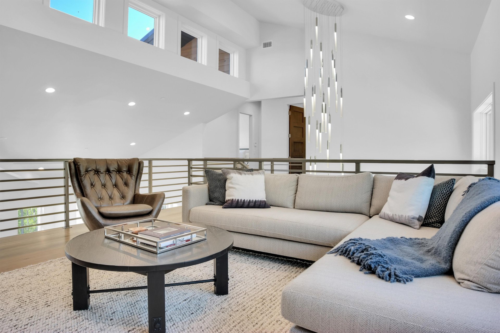 Vacation rental second living room with sectional sofa, club chair, and coffee table.
