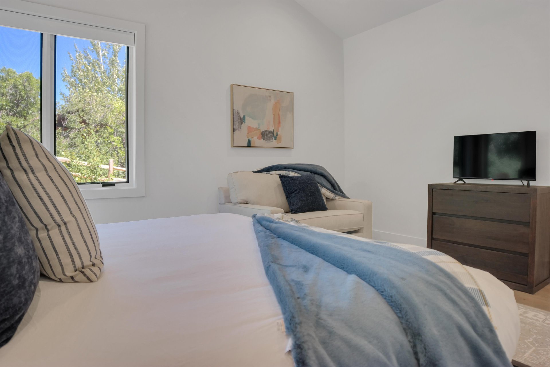 Vacation rental bedroom with cozy additional seating.