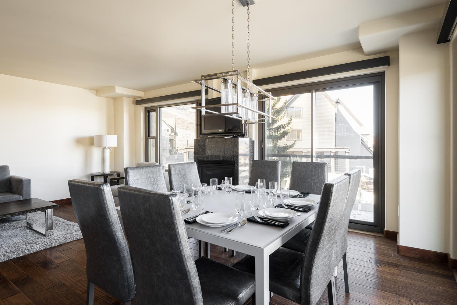 Square dining room table fully set with seating for 8