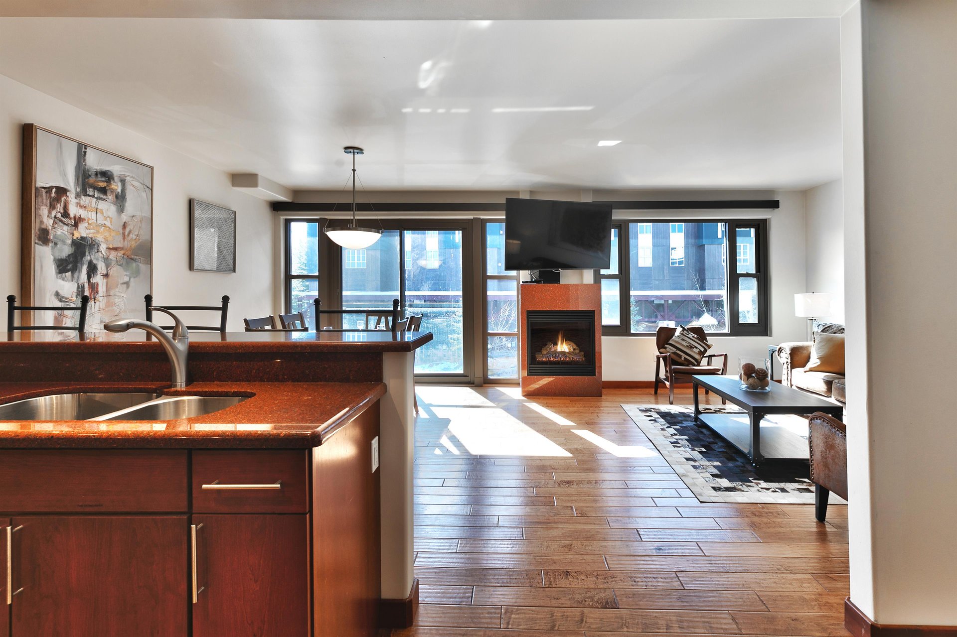 Open floor plan, kitchen leads to the dining room and living room with the granite surround fireplace in the center