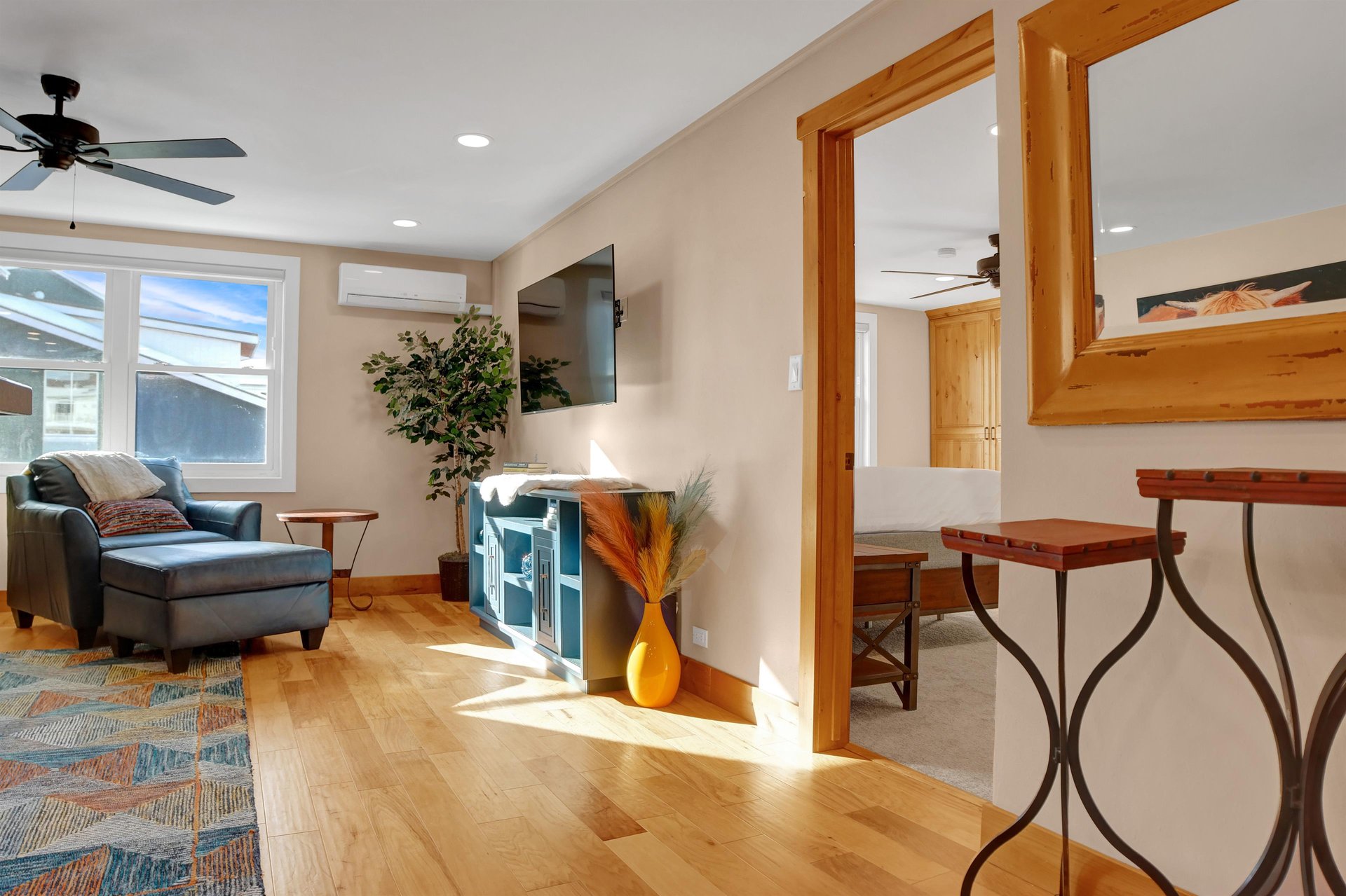 Hardwood floors throughout the living room, living area leads to the bedroom