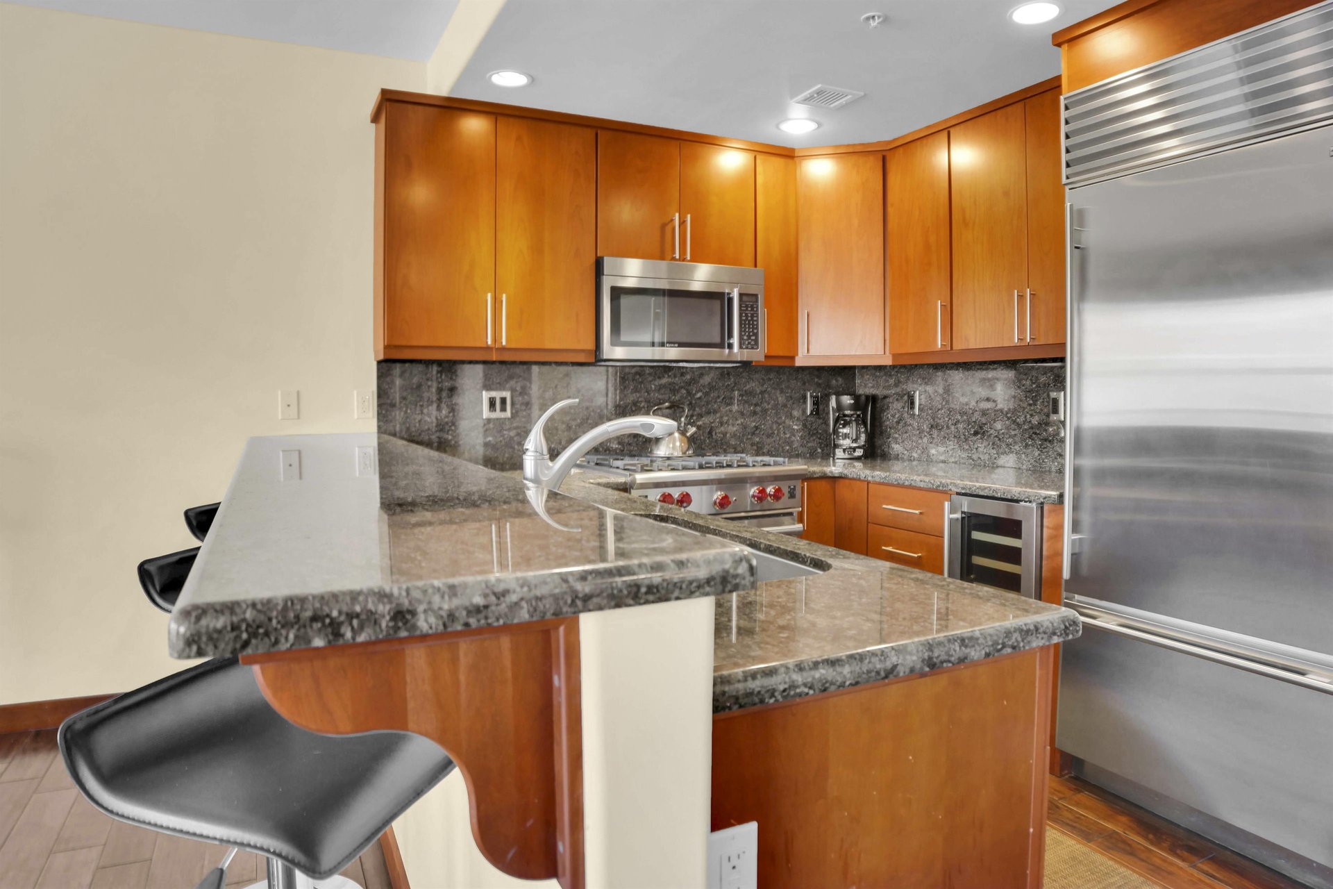 Lowell 304s kitchen with bar height breakfast bar next to the regular height counter where a sink is located.