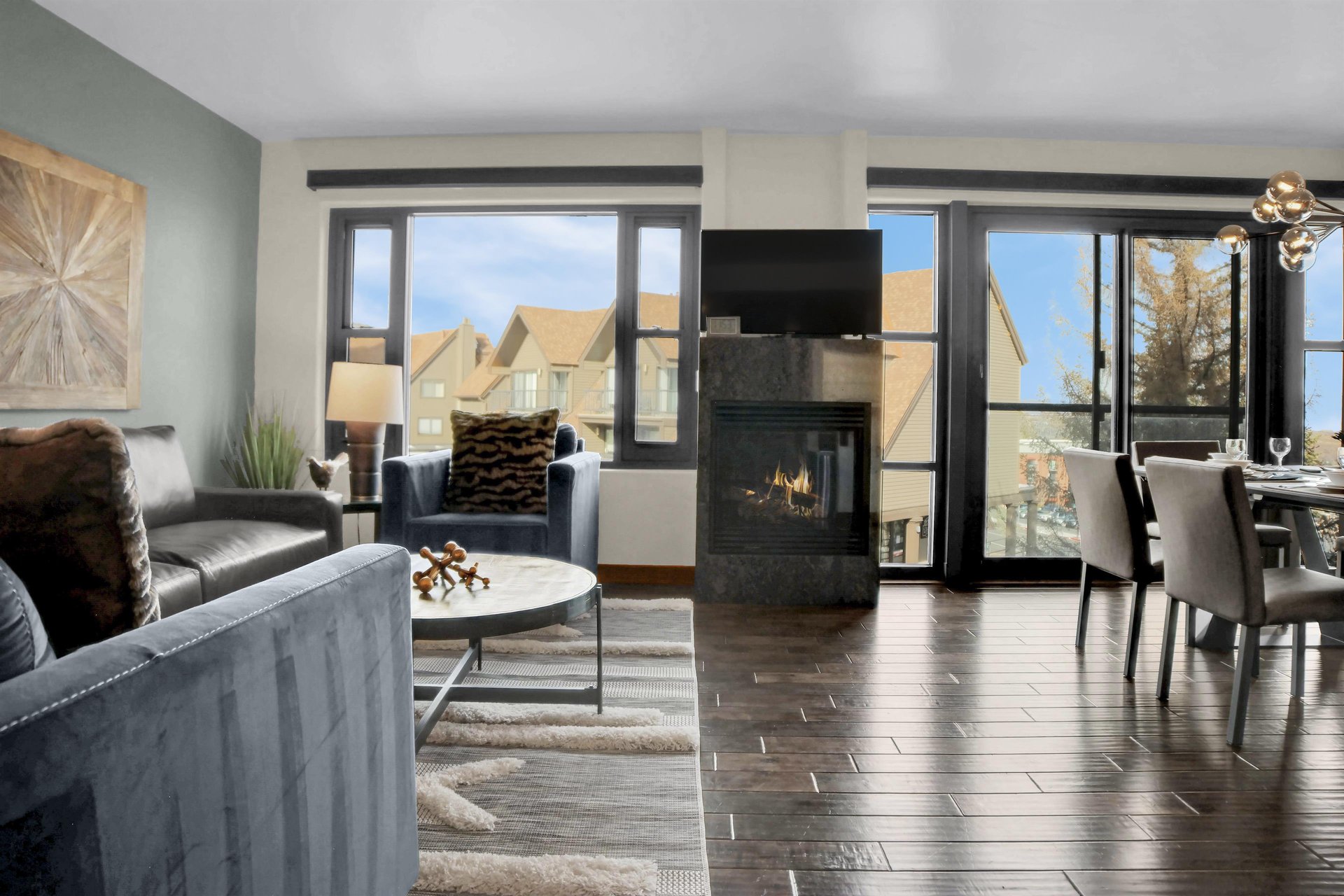 The gas fireplace with TV above separates two large windows.