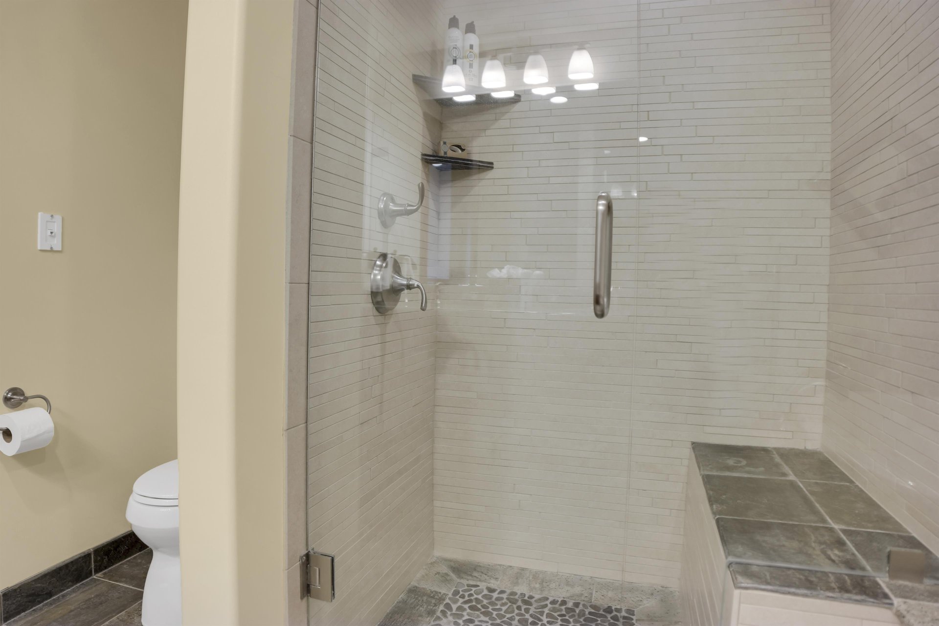 Lowell 304s walkin shower with greige color tile and built in bench.