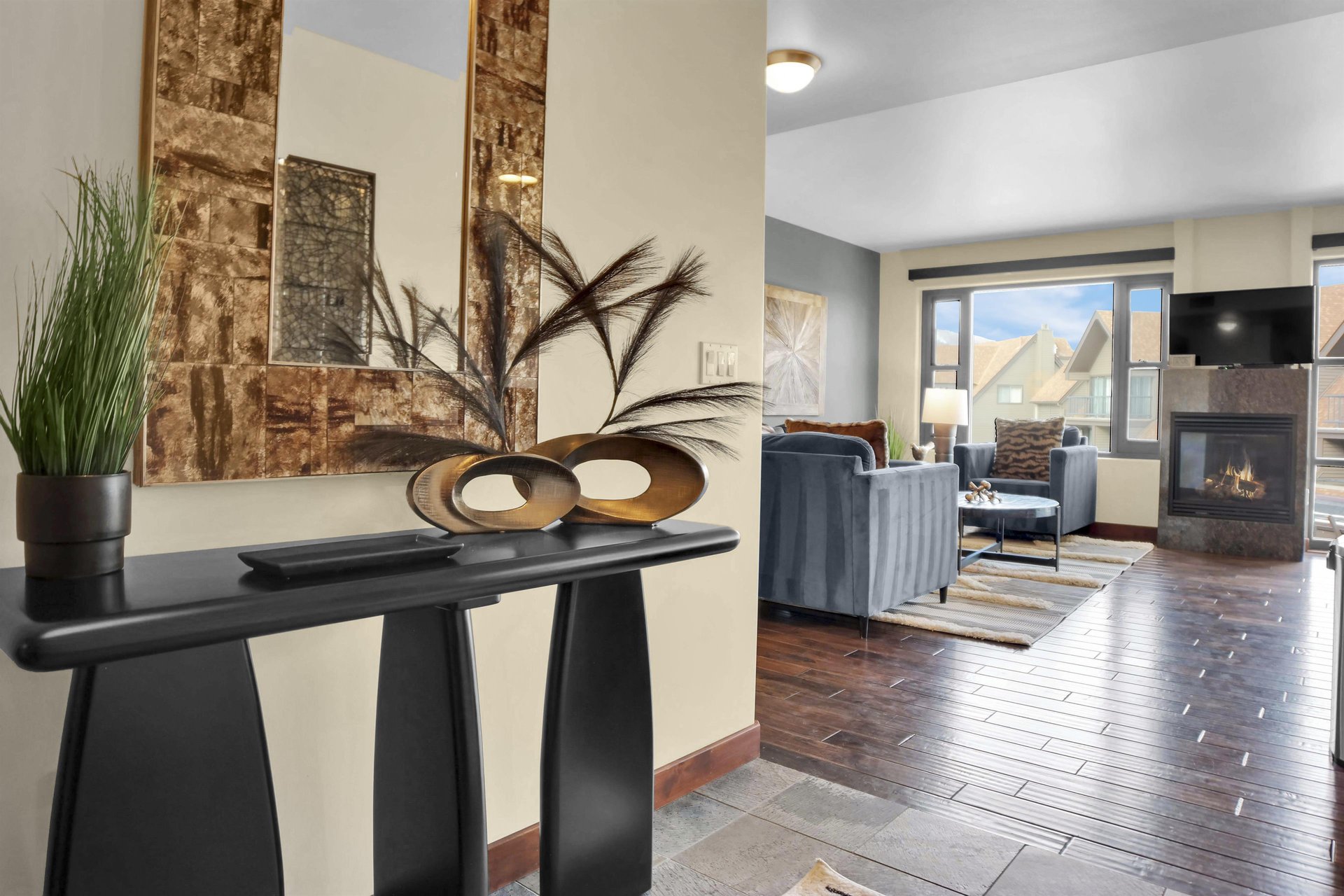 Lowell 304s entryway with stylish table, vases, mirror, and the living room beyond.