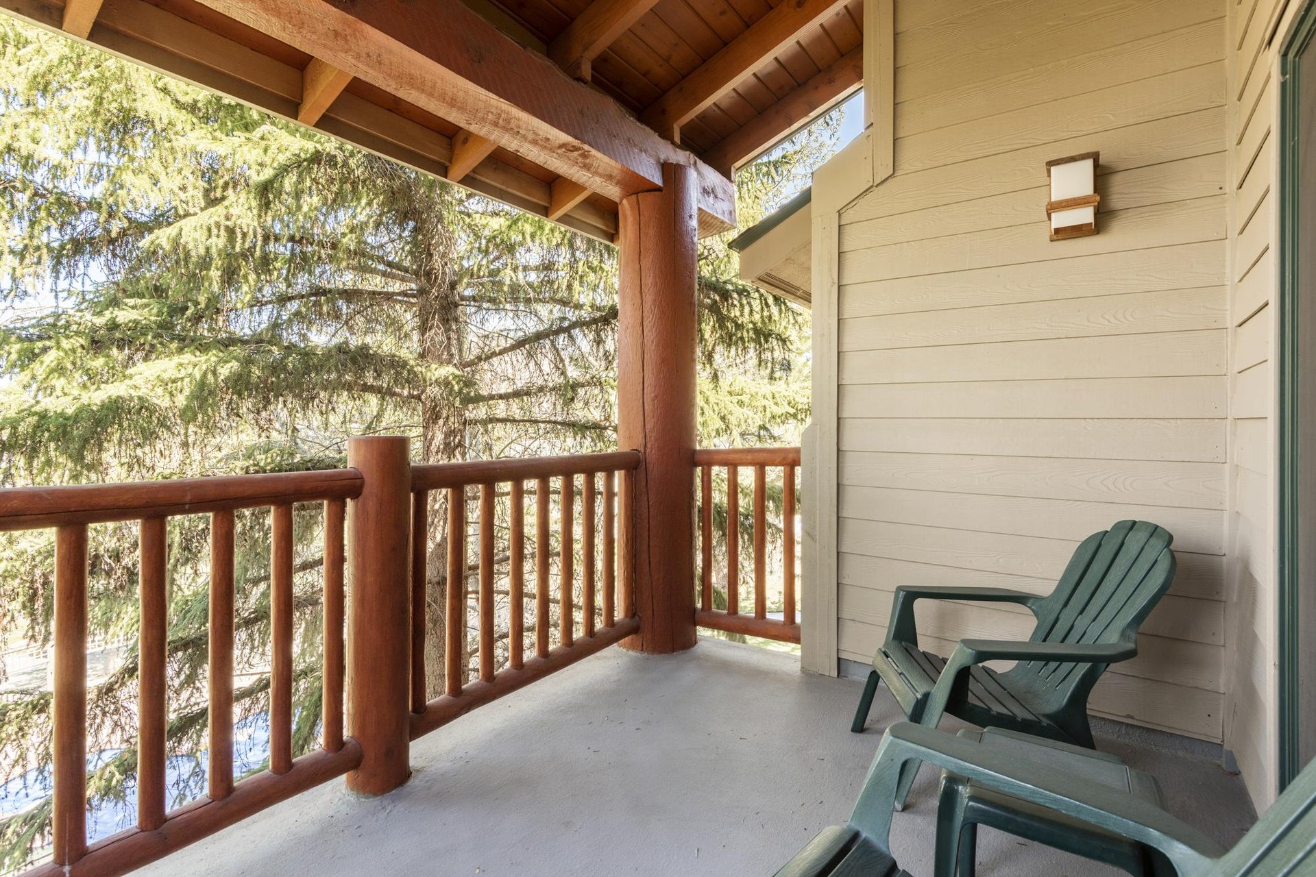 Enjoy your own private patio with two green chairs to relax in.