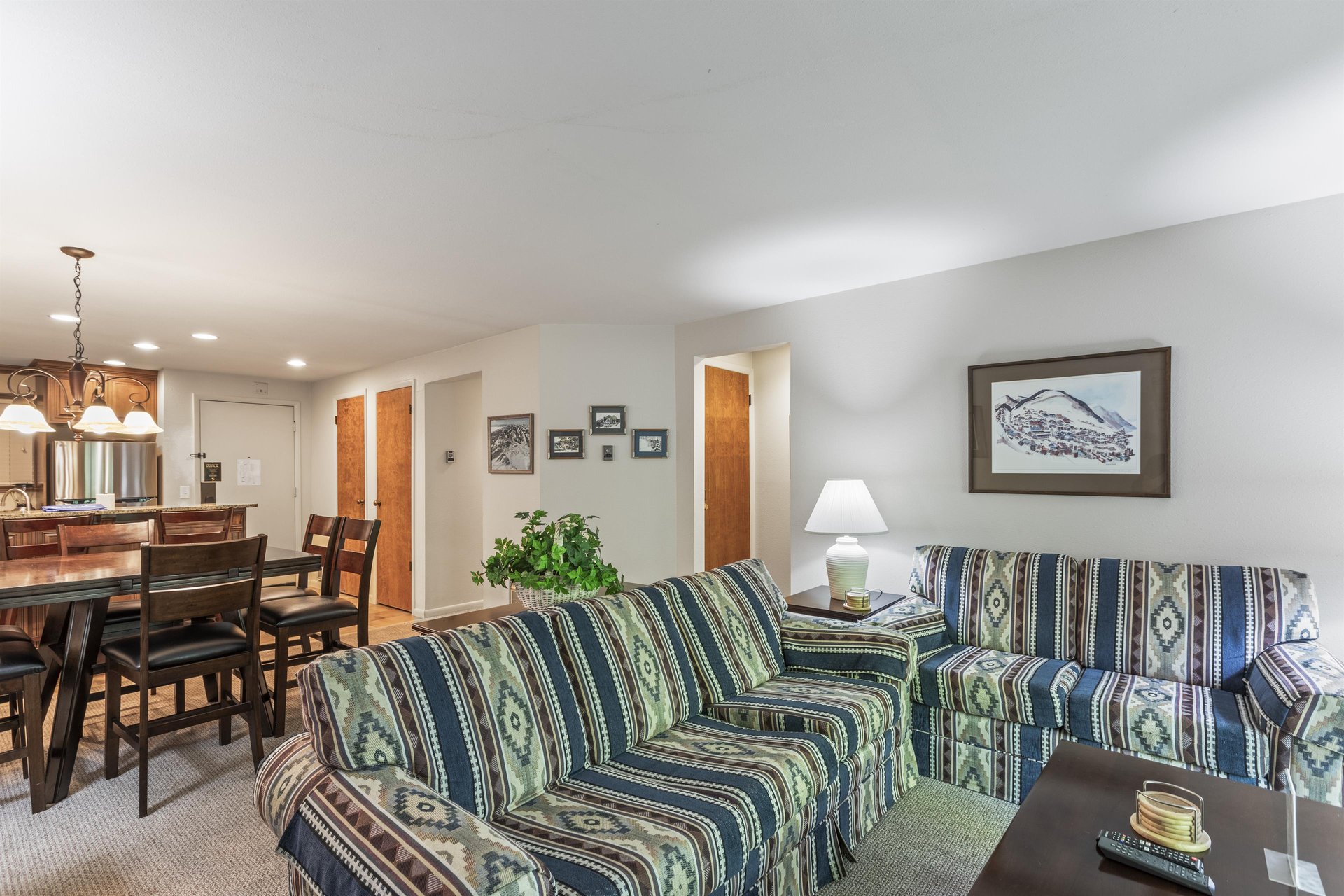 Snow Flower 135s living room with southwestern upholstered couch and the open concept dining room.