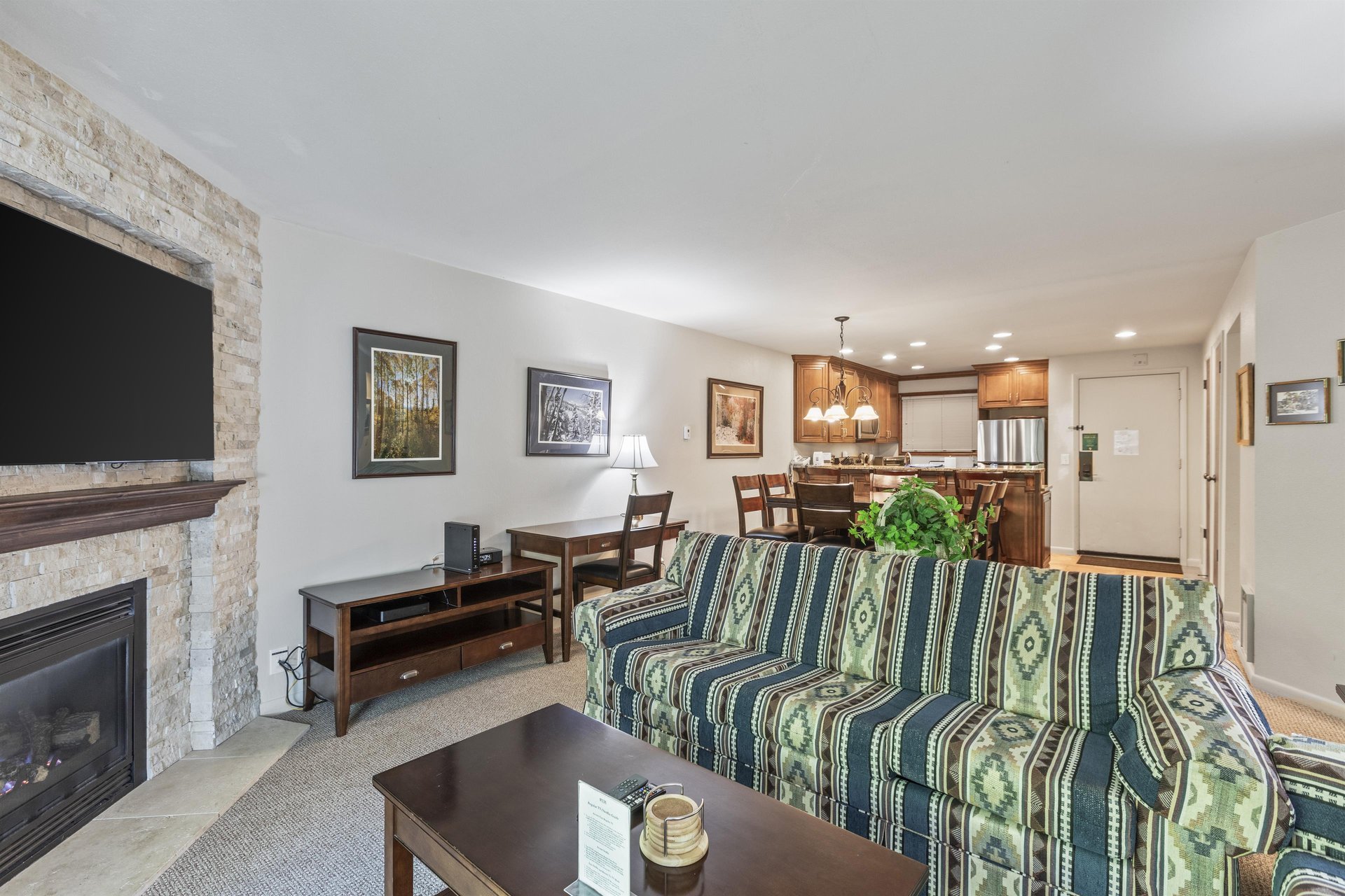 Snow Flower 135s living room with southwestern upholstered couch and the open concept dining room.