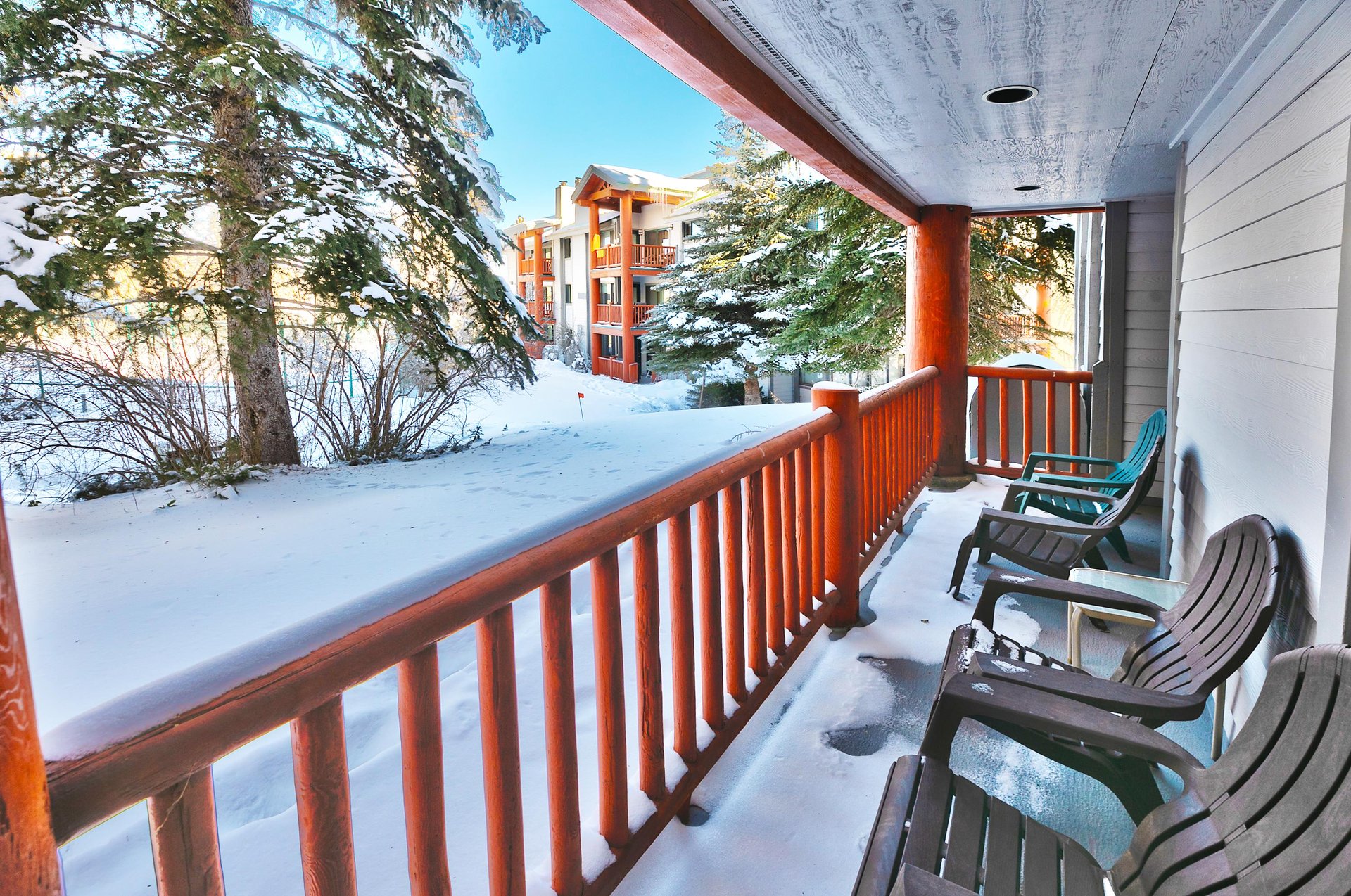 Private patio overlooks pine trees and the tennis courts