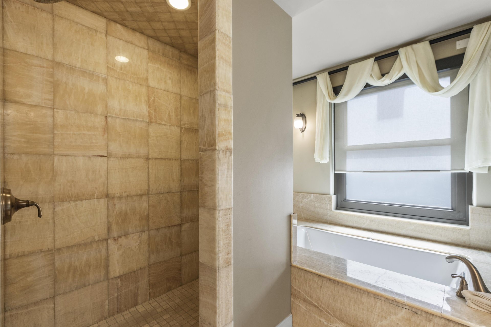 The second bedrooms en suite bathroom has a walk in shower and deep jetted tub.