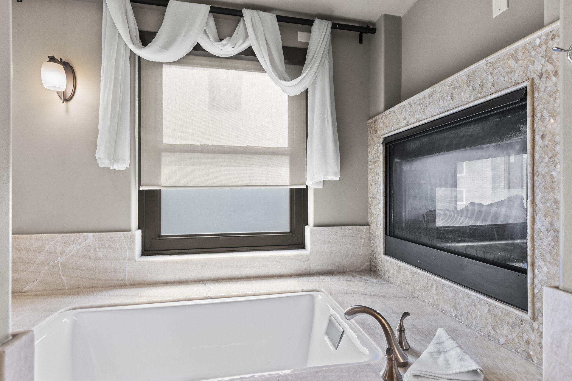 The second bedrooms en suite bathroom has a fireplace above a deep jetted tub.