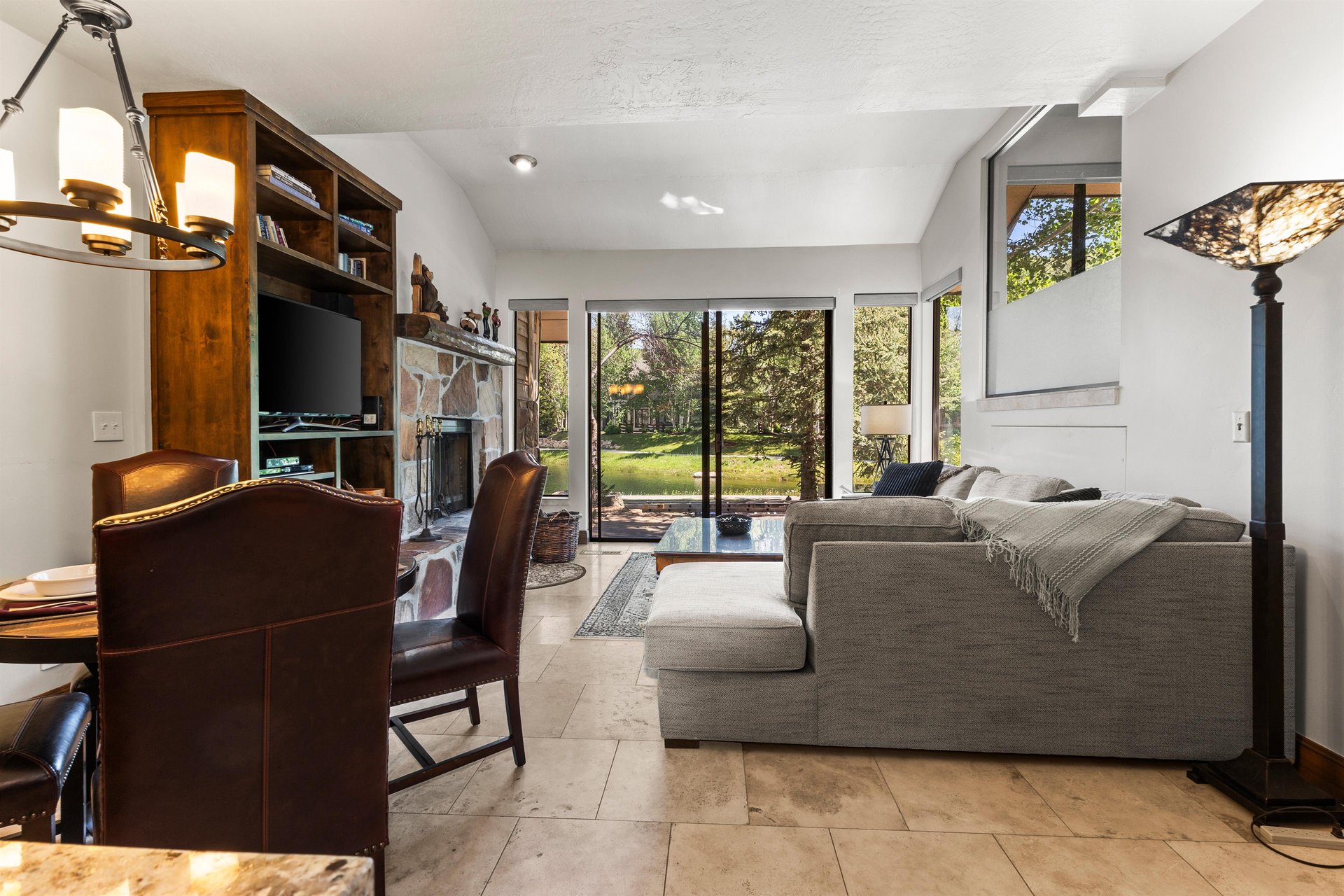 The living rooms open concept living room, fireplace, dining area, plus large windows allow plenty of natural light.