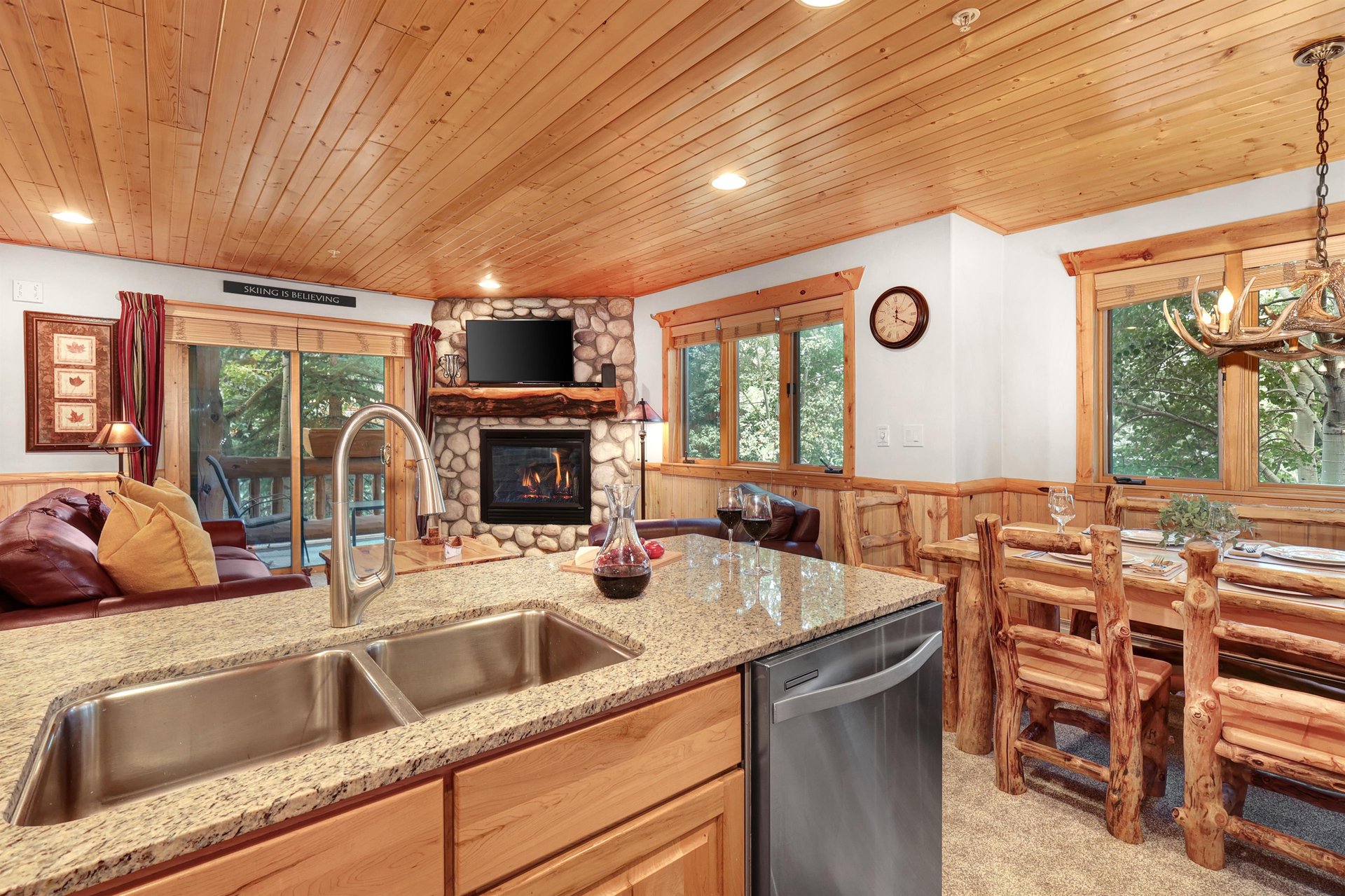 The open concept kitchen flows into the dining and living areas.