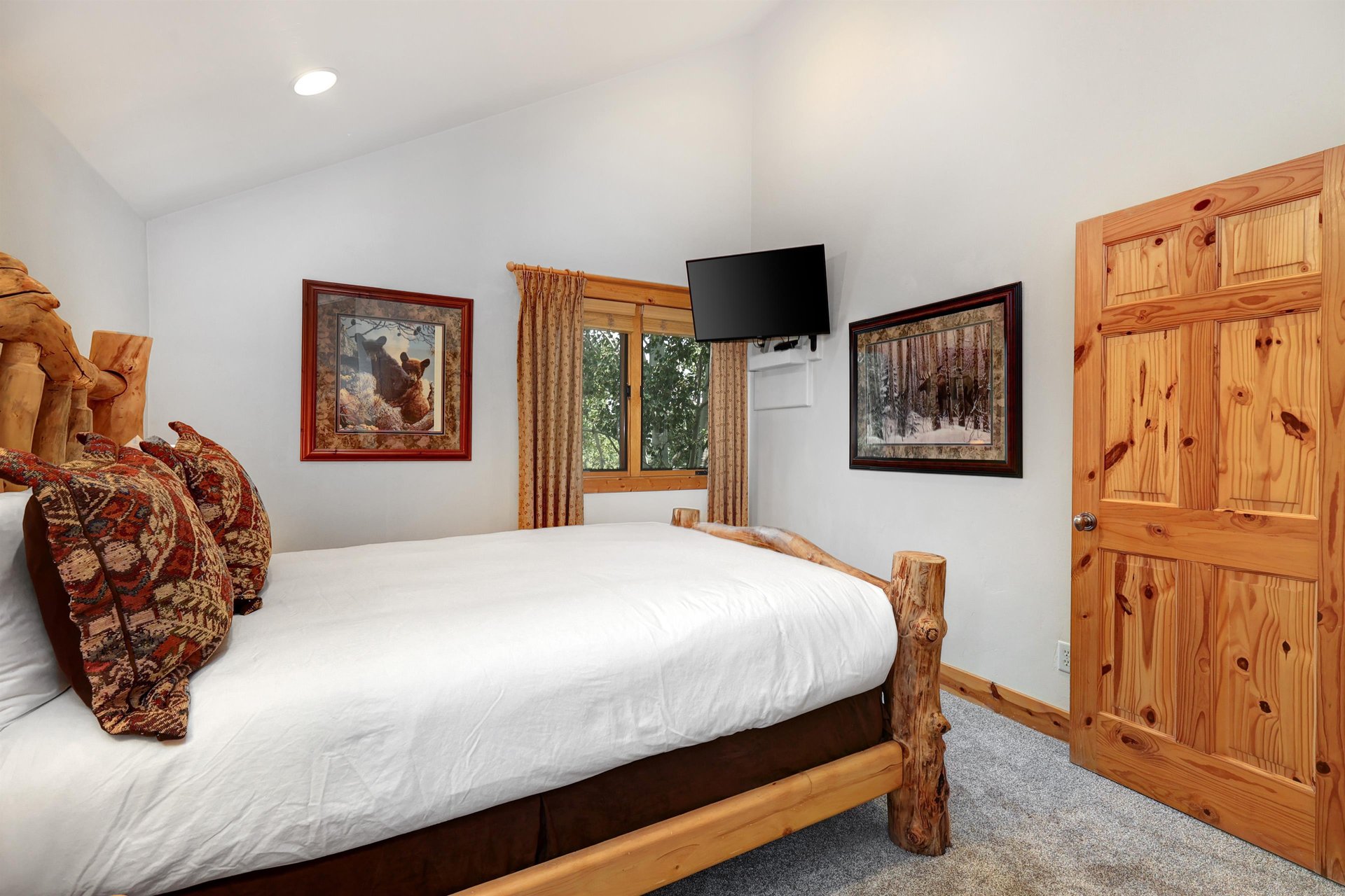 The second bedroom has a queen size bed, log style furniture, and flat screen TV.