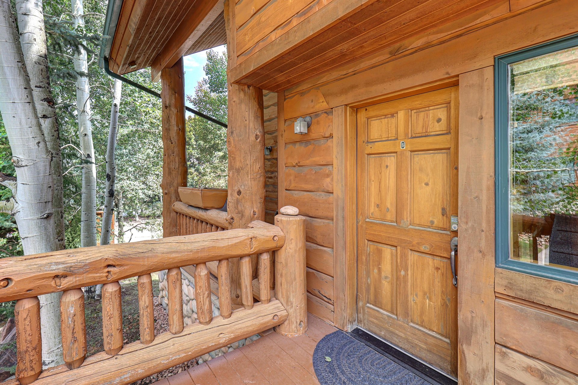 Timber Wolf Lodge 10 D has a beautiful log exterior and wood entry door.