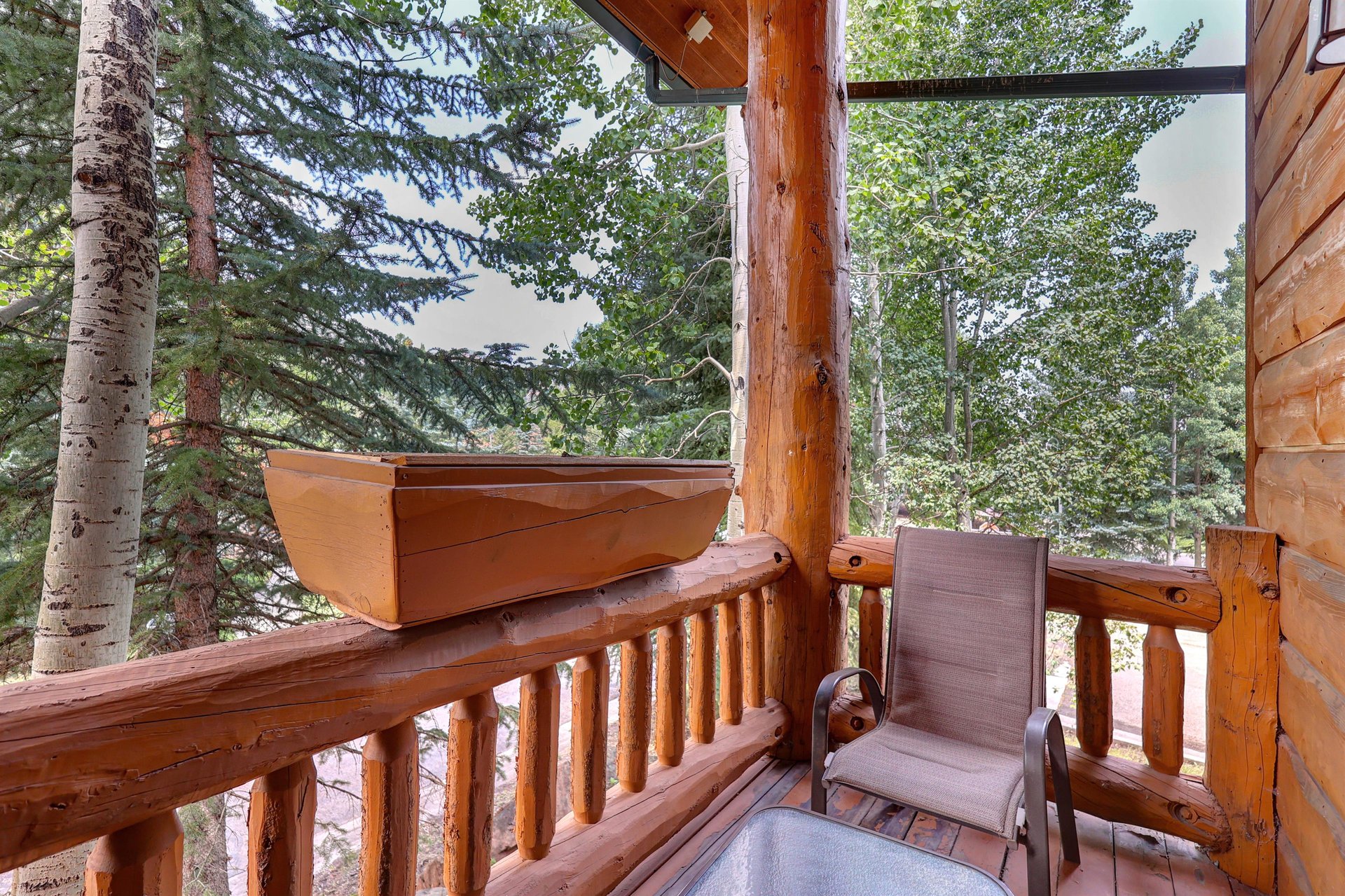 Timber Wolf Lodge 10 D has a sitting area with a small table and two chairs on a private deck.