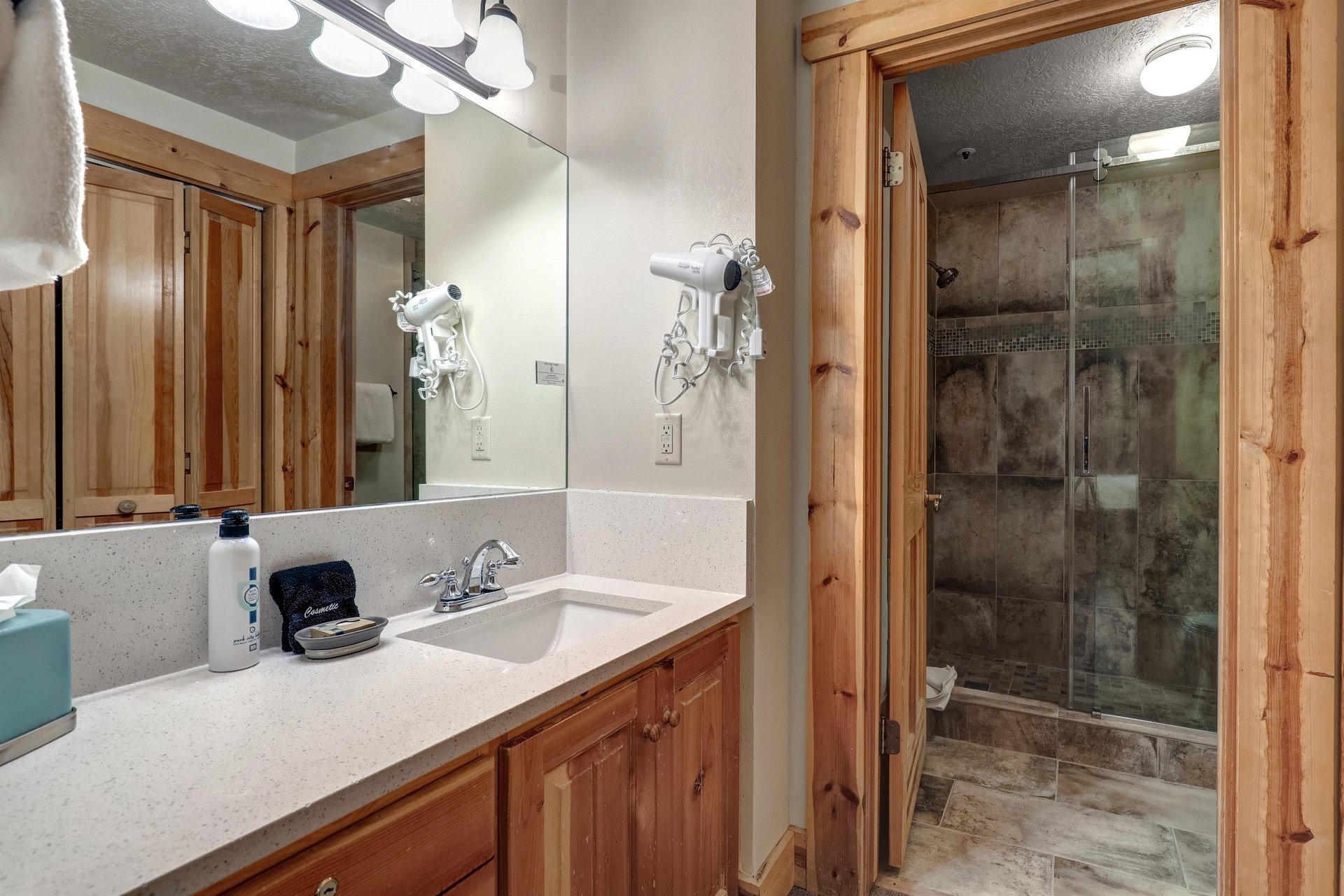 Main suite bathroom with one sink vanity and walk in tiled shower.
