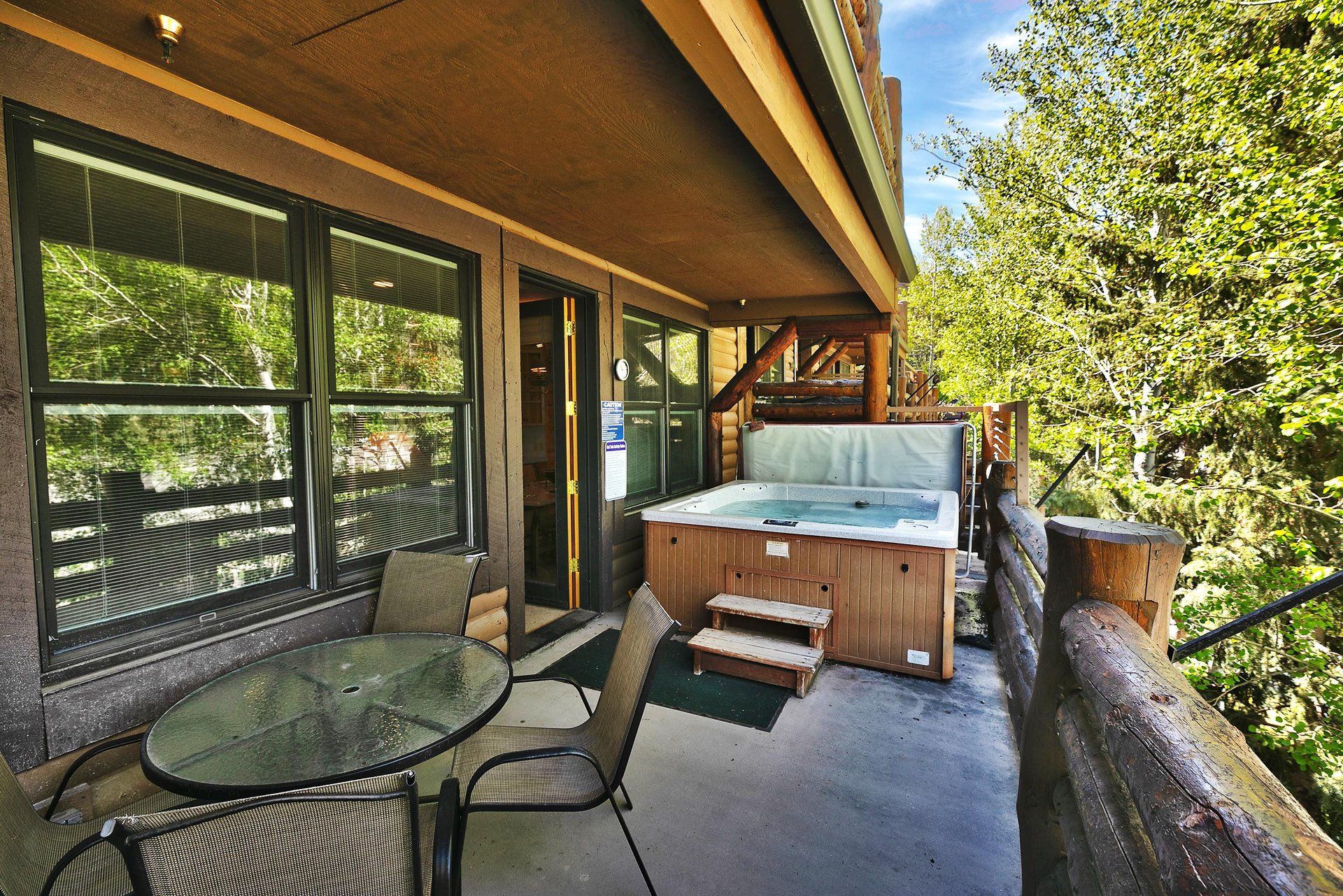 Spacious private deck with hot tub and patio dining set