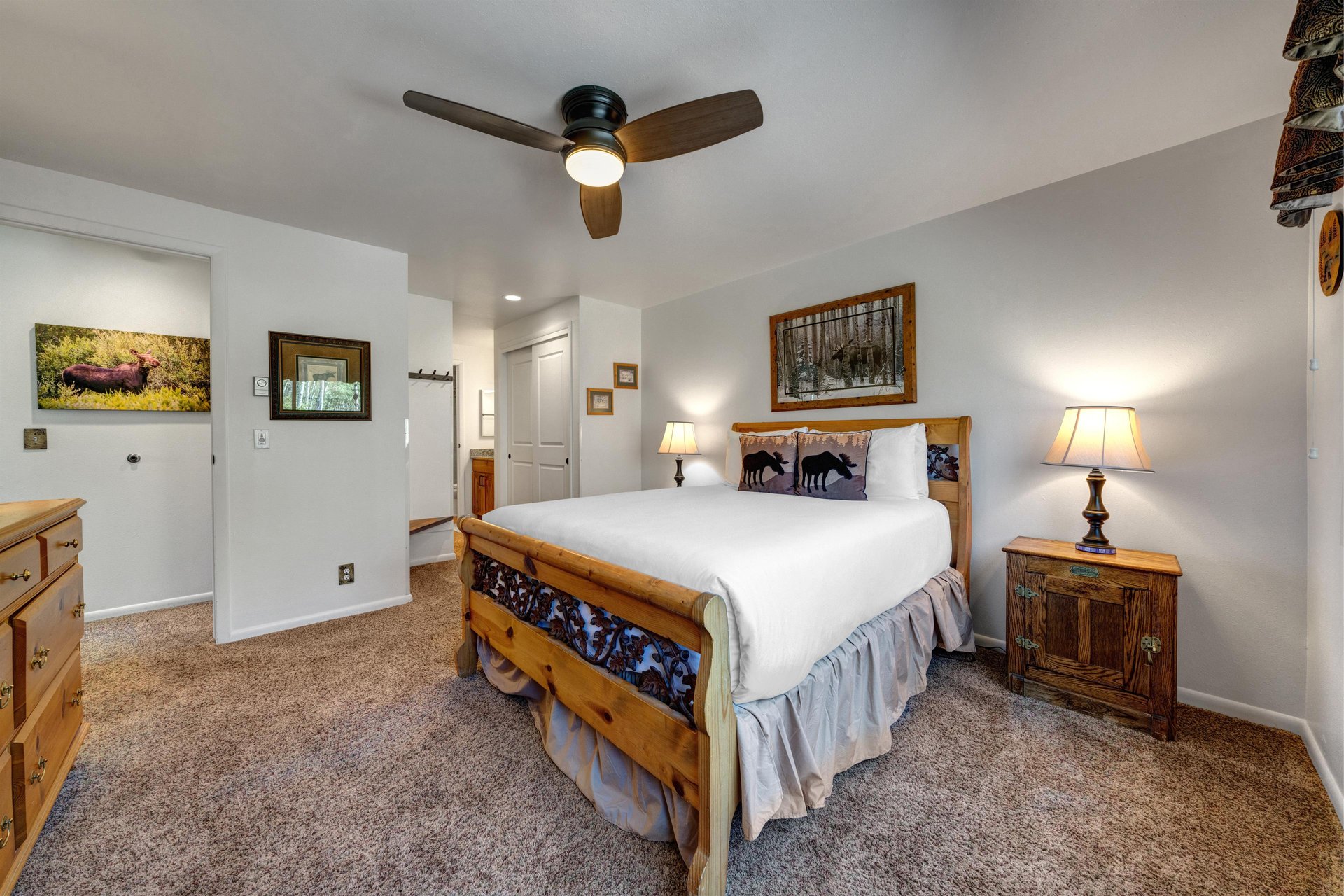 The main bedroom features a comfortable queensized bed with white linen